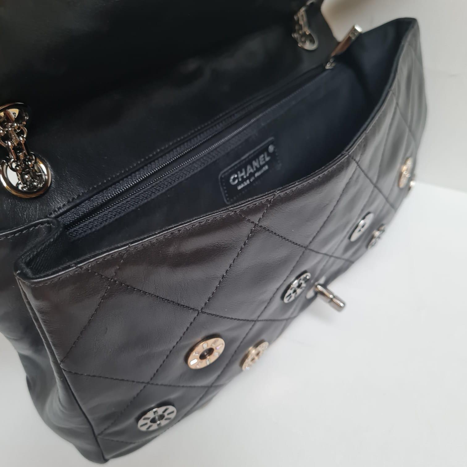 A rare coin embellishment jumbo flap bag. Black supple leather with beautiful embellishments. Minor wear on the corners. Series #11. Comes with its card and dust bag. 