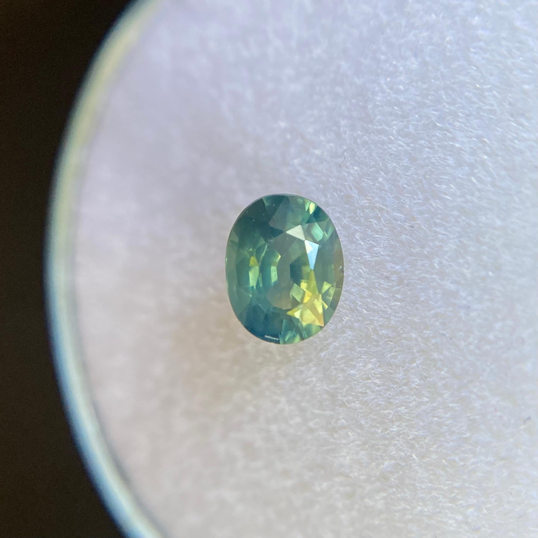 Natural Greenish Yellow Blue Parti-Colour Australian Sapphire Gemstone.

0.61 Carat with a beautiful and unique greenish yellow blue colour and excellent clarity, a very clean stone with only some small natural inclusions visible when looking