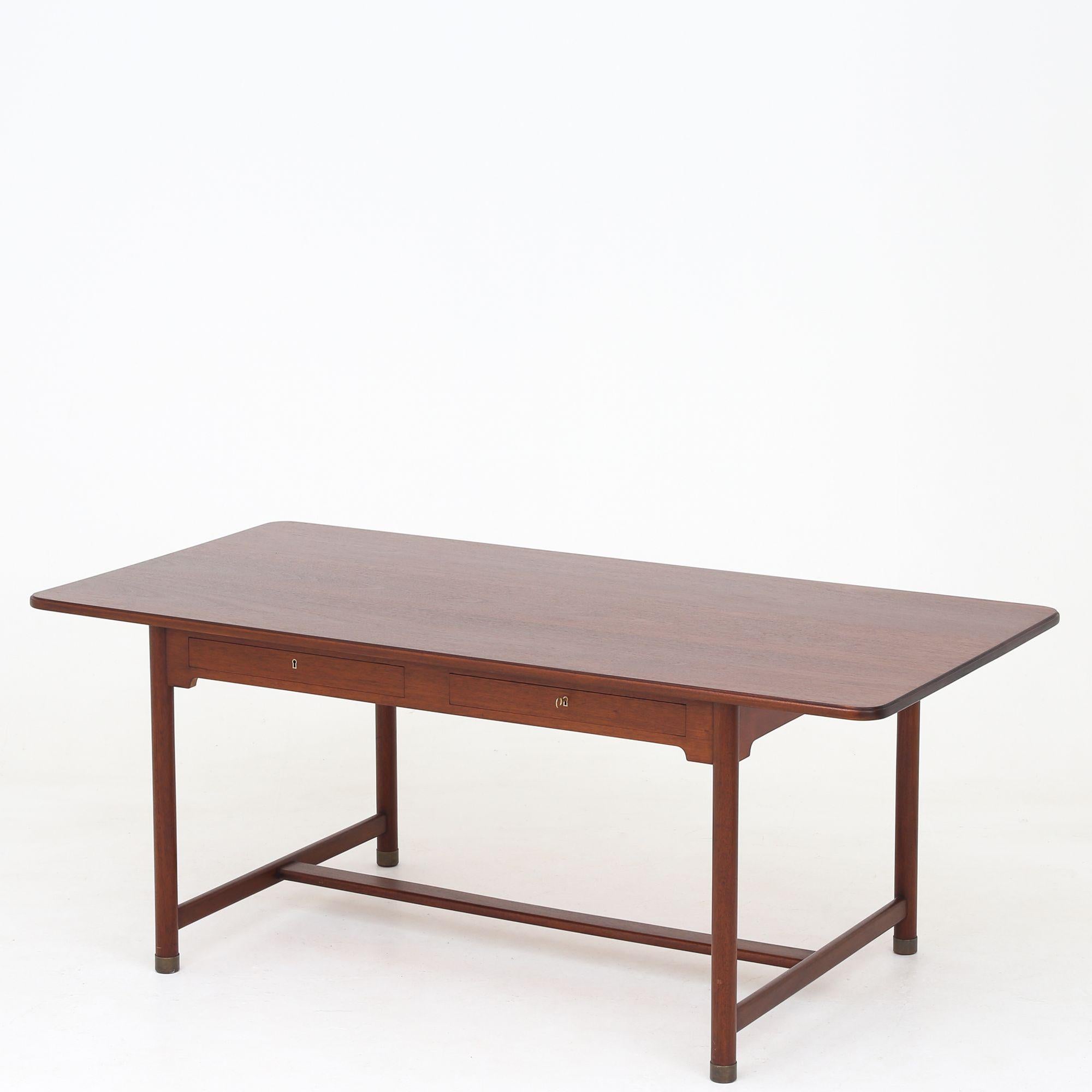 Rare 'Partners Desk' mahogany desk with four drawers, profiled edge and brass shoes. Designed in 1938. Mogens Koch / N. C. Jensen Kjær.
