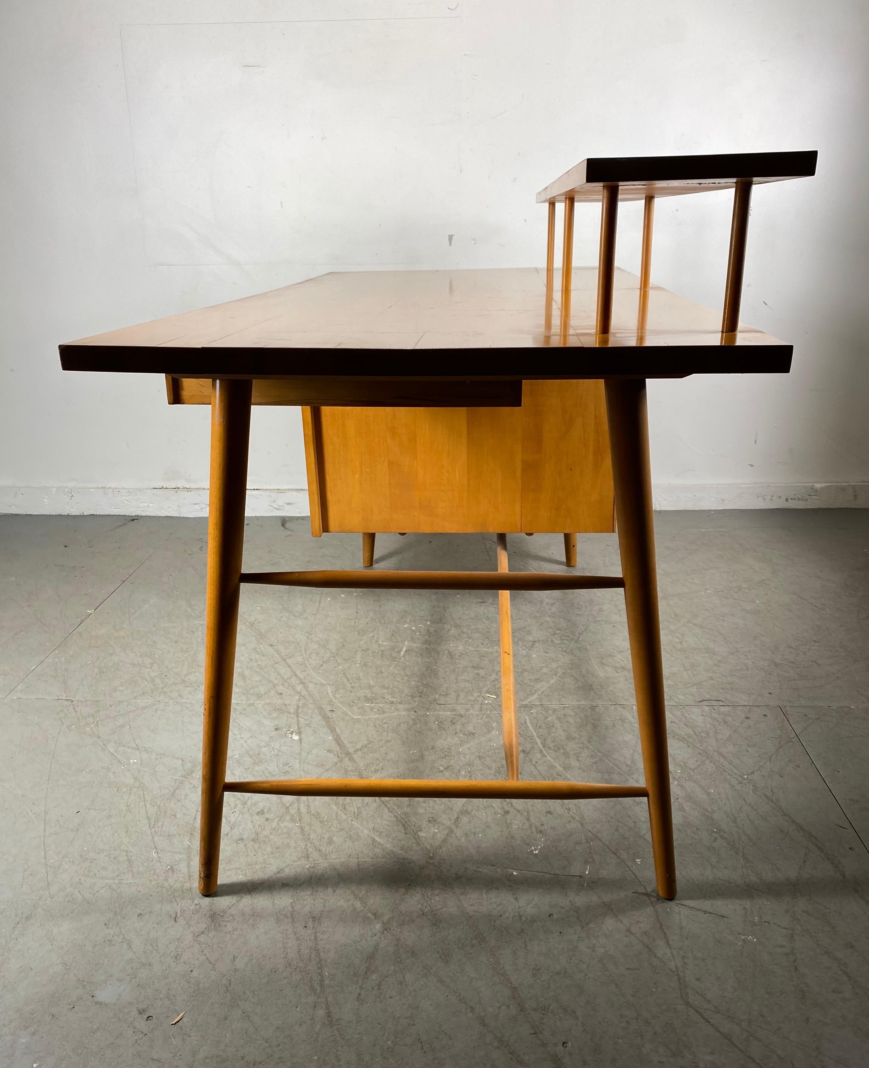Seldom seen Paul McCobb for Winchendom Furniture Company, desk, maple, United States, 1950s

Elegant maple desk with one sided pedestal with a large storage compartment and three small drawers on the other side. The desk is executed with slender