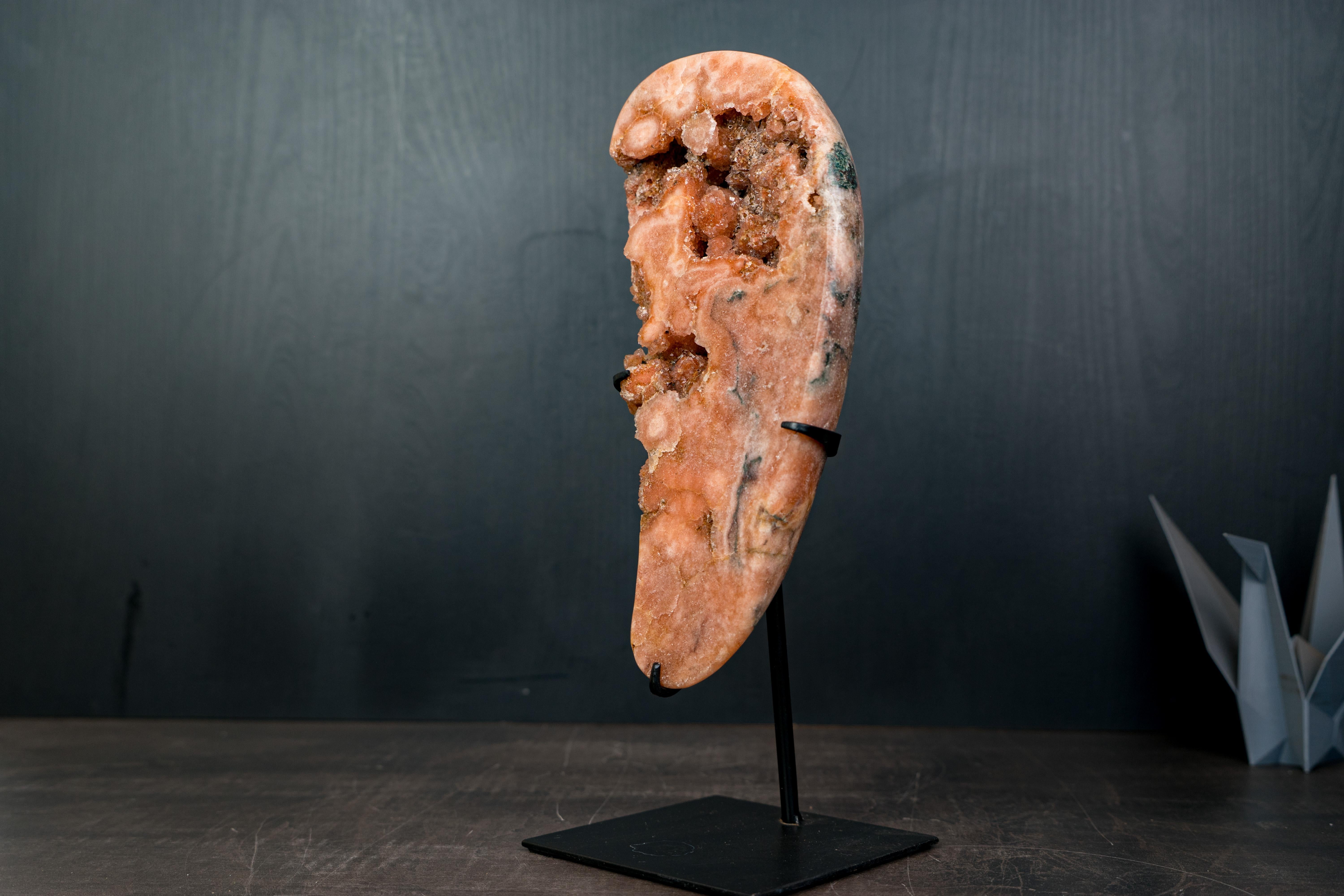 Natural Pink Amethyst Geode Slab with Peach-Pink Druzy Crystals on Stand

▫️ Description

You might be wondering — is this vivid peach-pink color natural? The answer is yes. The rich pink tones in this Pink Amethyst geode are 100% natural, formed