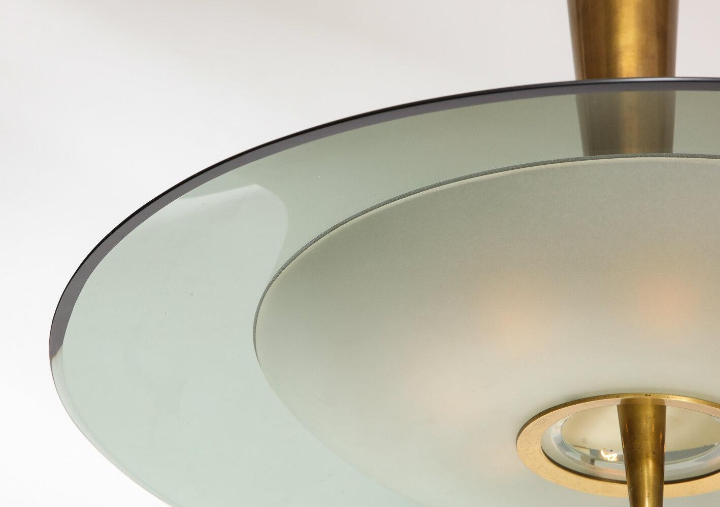 Large saucer pendant featuring a large pale green glass dish and a lower acid-etched bowl with brass mounts. 8 candelabra sockets, recently replaced and newly rewired.