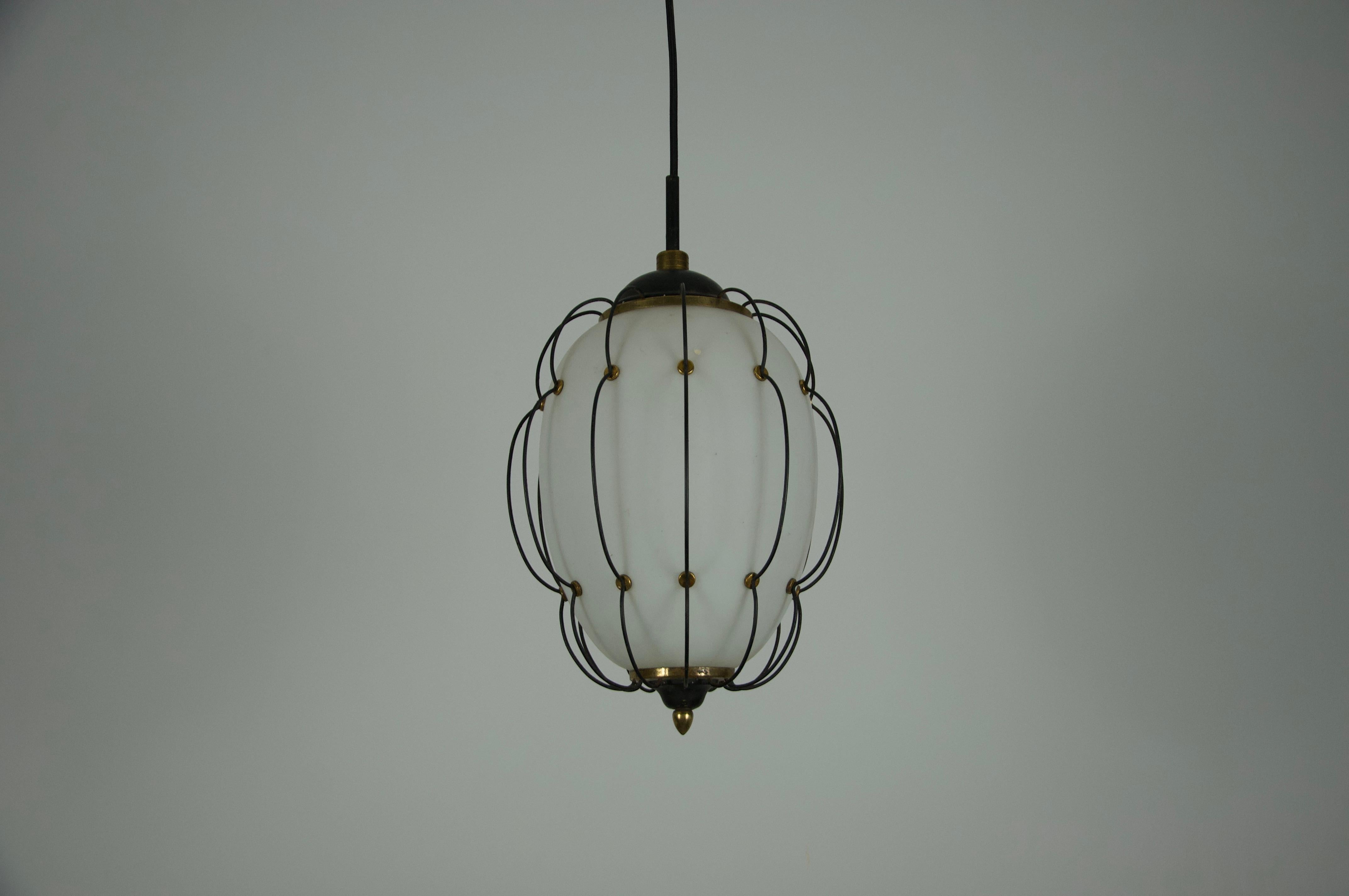 This rare pendant lamp, designed by Angelo Lelli for the renowned Italian manufacturer Arredoluce in the 1950s, is an exceptional example of mid-century Italian design. The lamp features a softly glowing opaline glass shade, enclosed within an