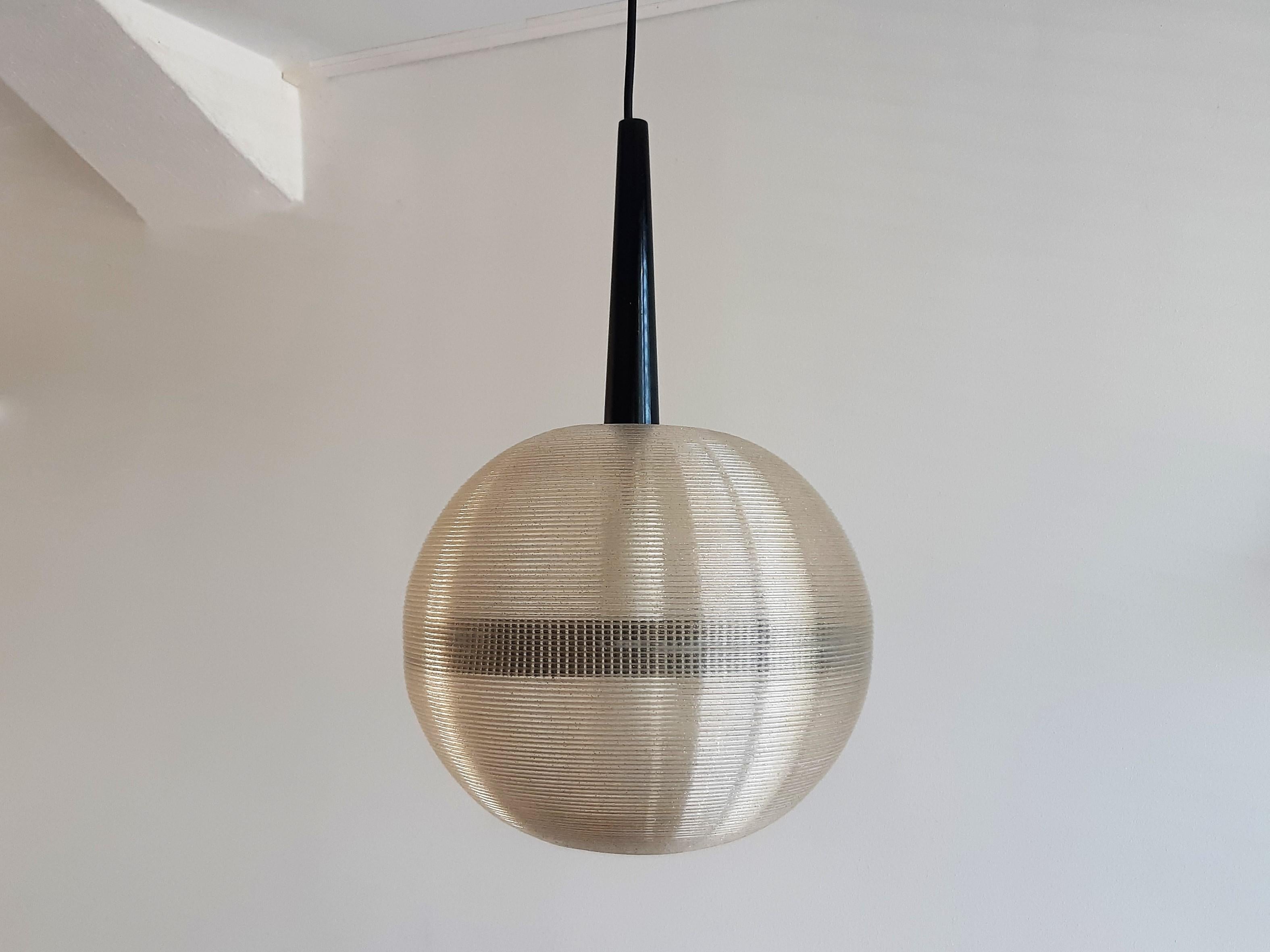 This rare pendant lamp was designed by John Reed for Rotaflex, in the 1950's/1960's. A very beautiful design because of the simplicity. The shade is made out of Cellulose Acetate (plastics) with a black wooden top. The use of material spreads and