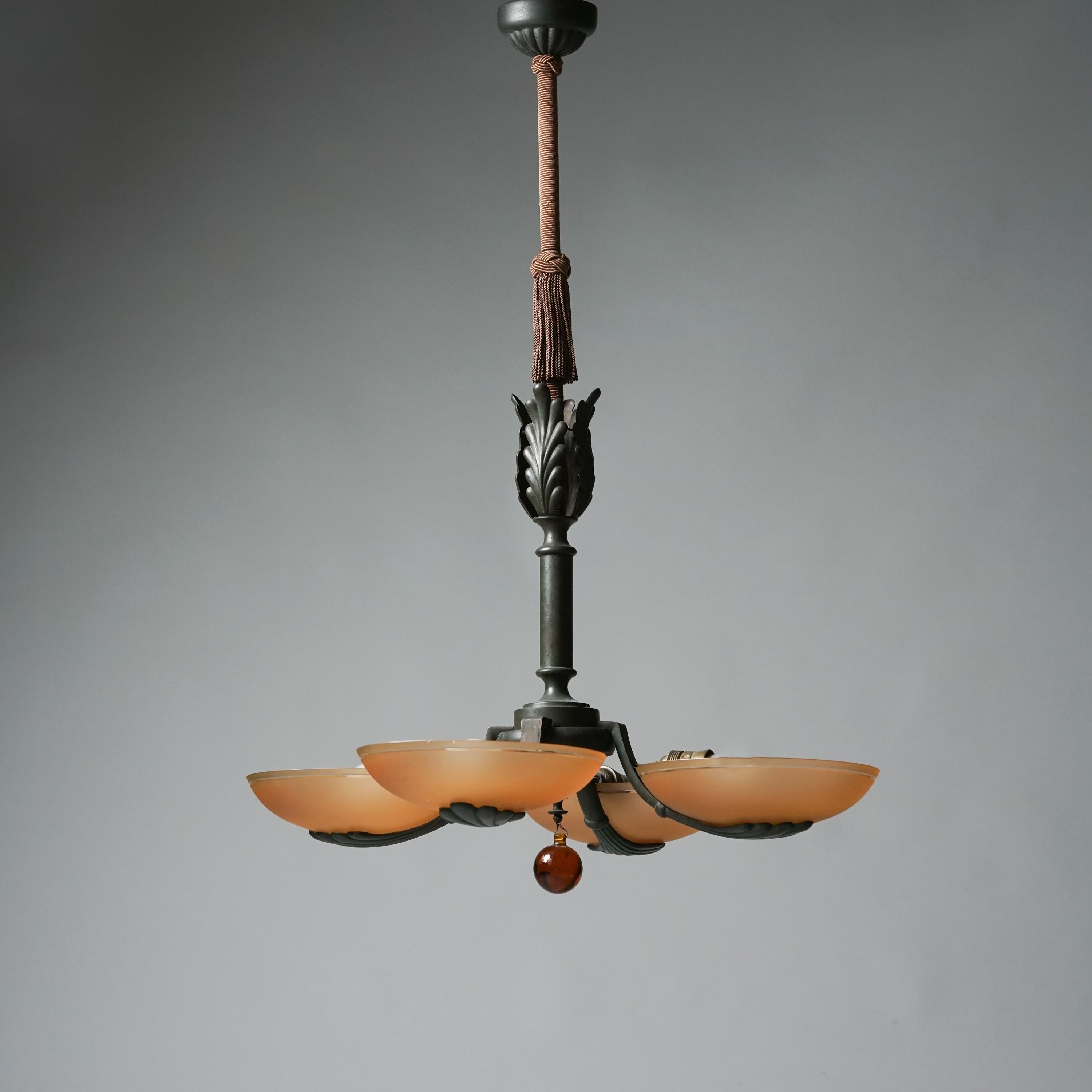 Pendant model 479/4 by Taidetakomo Hakkarainen from the 1930s. Forged iron frame with opaline glass shades, glass detail and braided fabric detail. Good vintage condition, patina and minor wear consistent with age and use. 
This model can be found