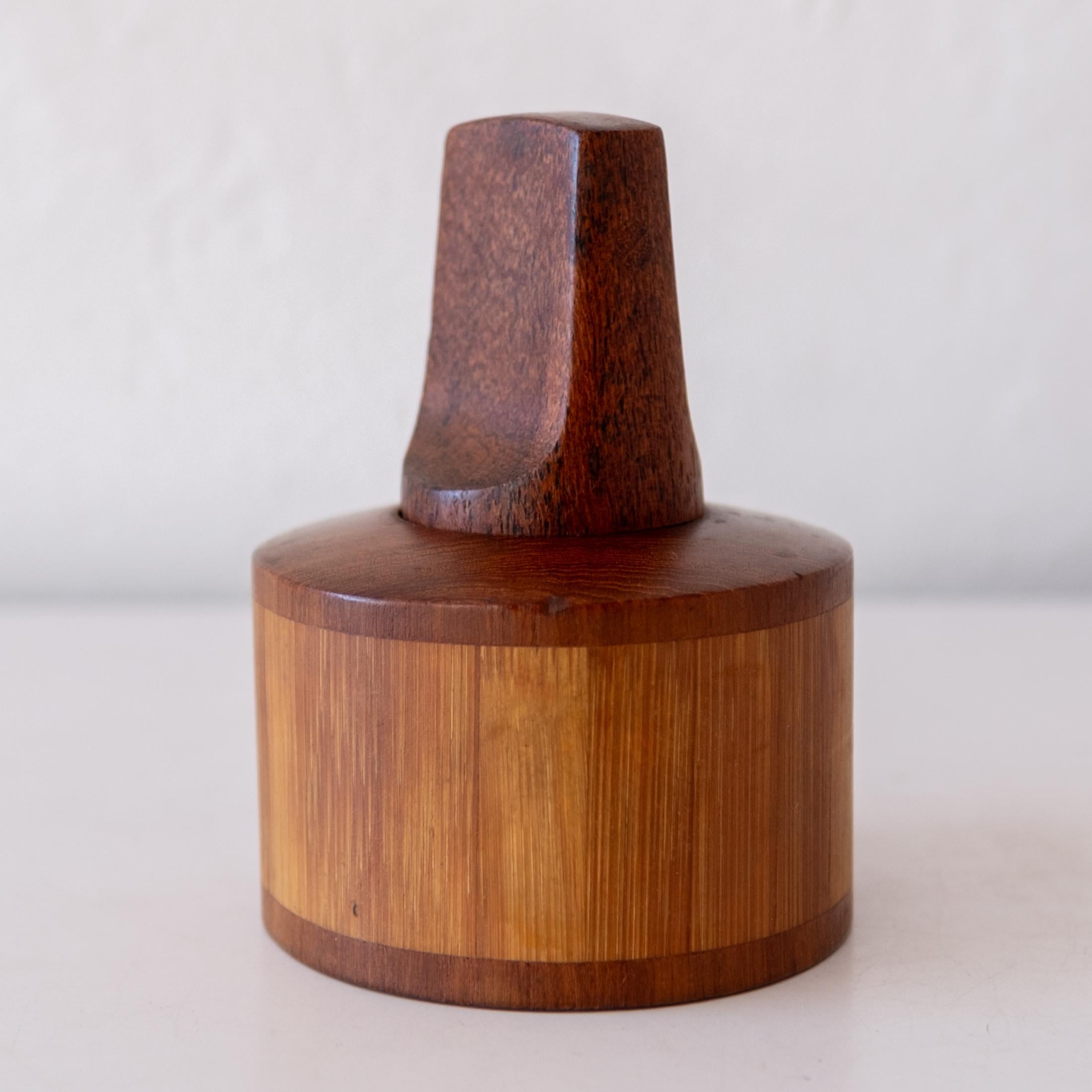 Early teak and cane/bamboo pepper mill by Jens Quistgaard. Metal grinding mechanisms produced by Peugeot Freres. The mill was produced by Dansk in Denmark. Marked DANMARK.