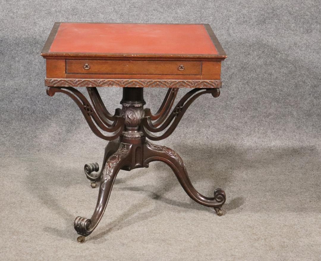 This is a very rare table. The table is Circa 1770 - 1800. Mahogany. Carved. 4 drawers. On casters. Metal hardware. Leather top. 27