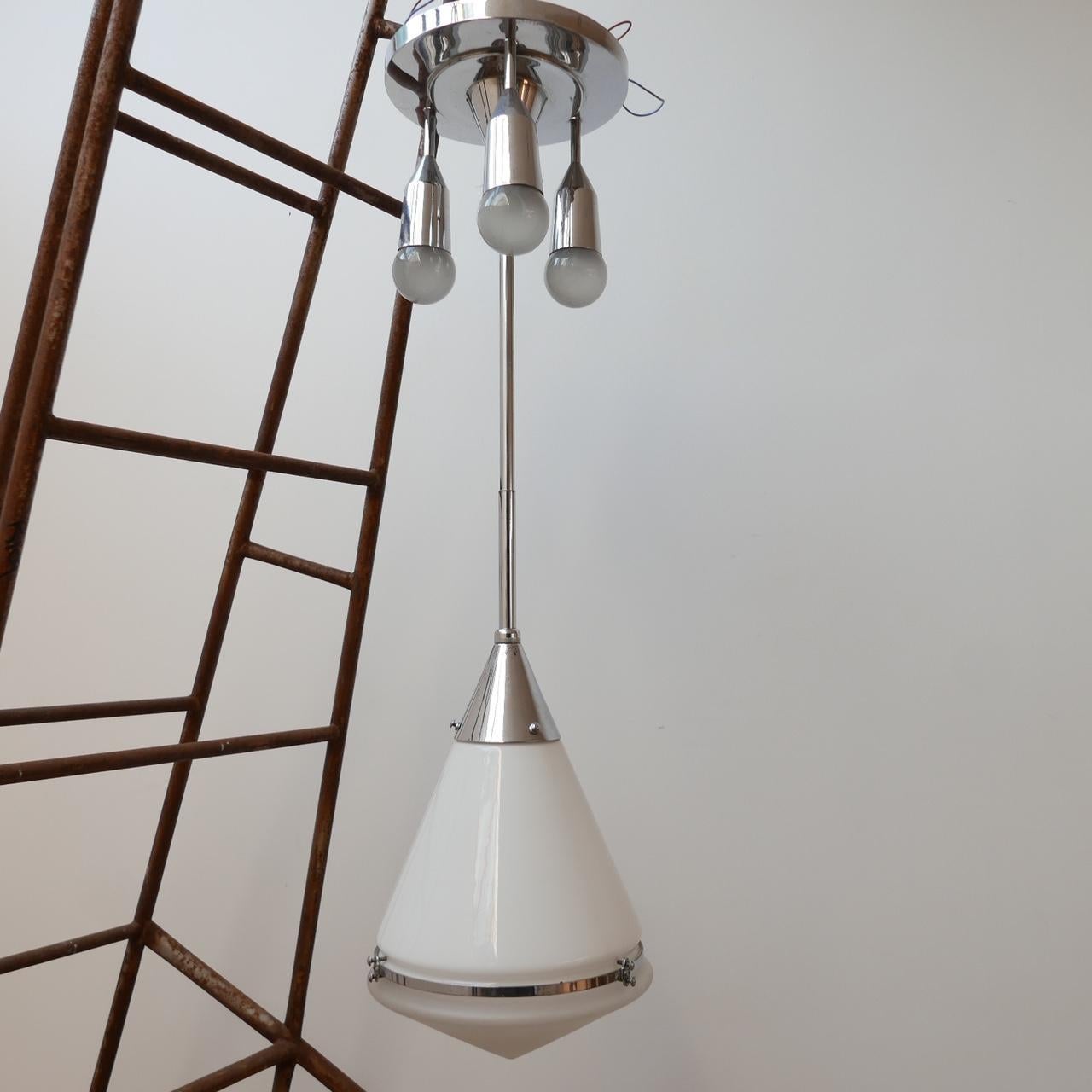 A wildly rare pendant chandelier by Peter Behrens for Siemens and Schuckert,

German, circa 1930s.

Opaline top glass, etched glass base.

Nickel rim and gallery.

The three light gallery is incredibly rare, it is documented in Siemens books