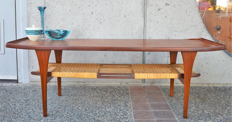 Rare Peter Lovig Nielsen Teak Coffee Table, Flared Ends and Cane Wrapped Shelf In Good Condition For Sale In New Westminster, British Columbia