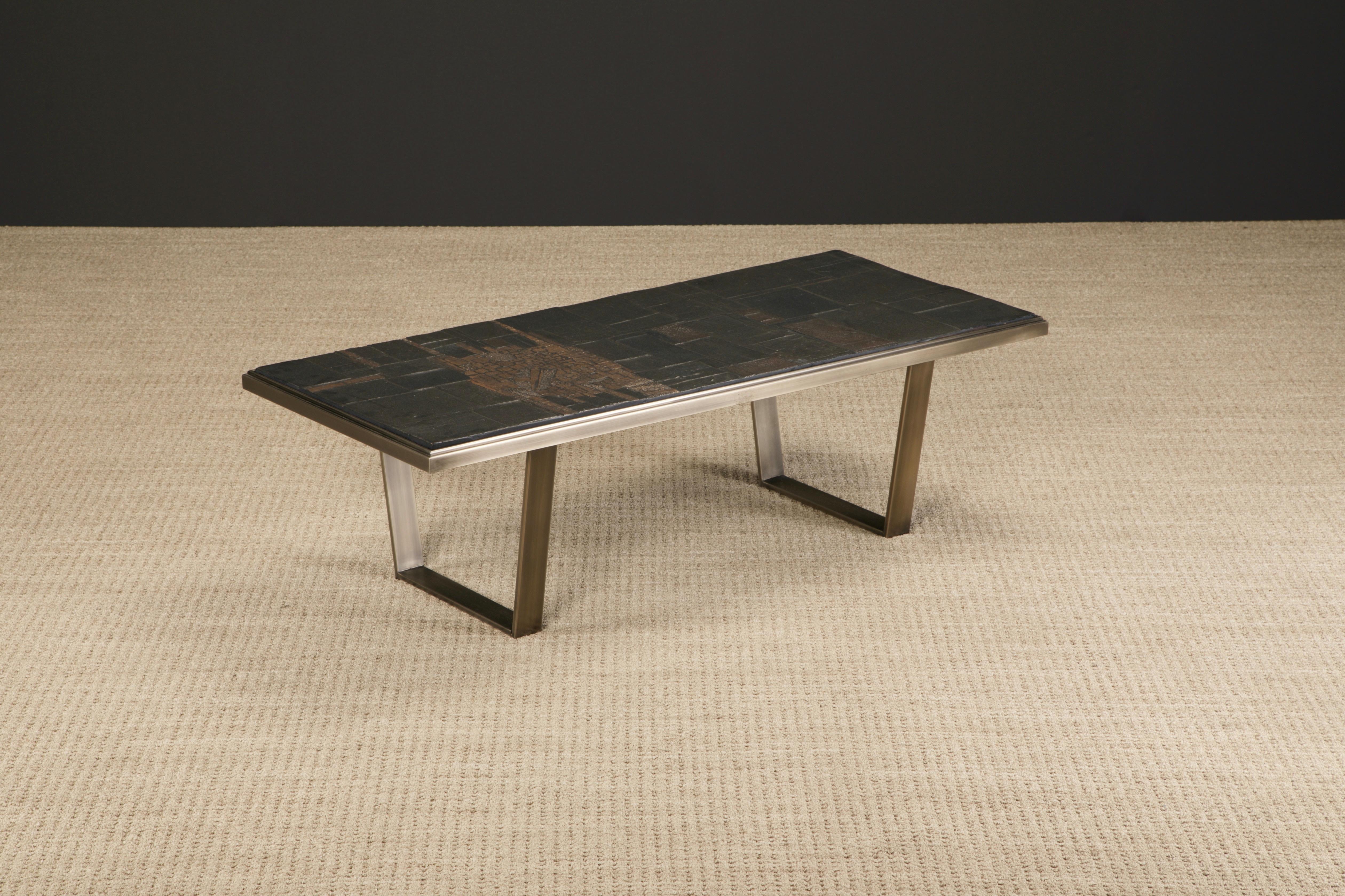 An incredible Pia Manu brutalist coffee table, circa 1965-1970s, with brutalist cast resin artwork top over a brushed copper-tone steel frame and base. This stunning piece of functional art is signed on top 'Pia Manu'. Excellent cocktail table for