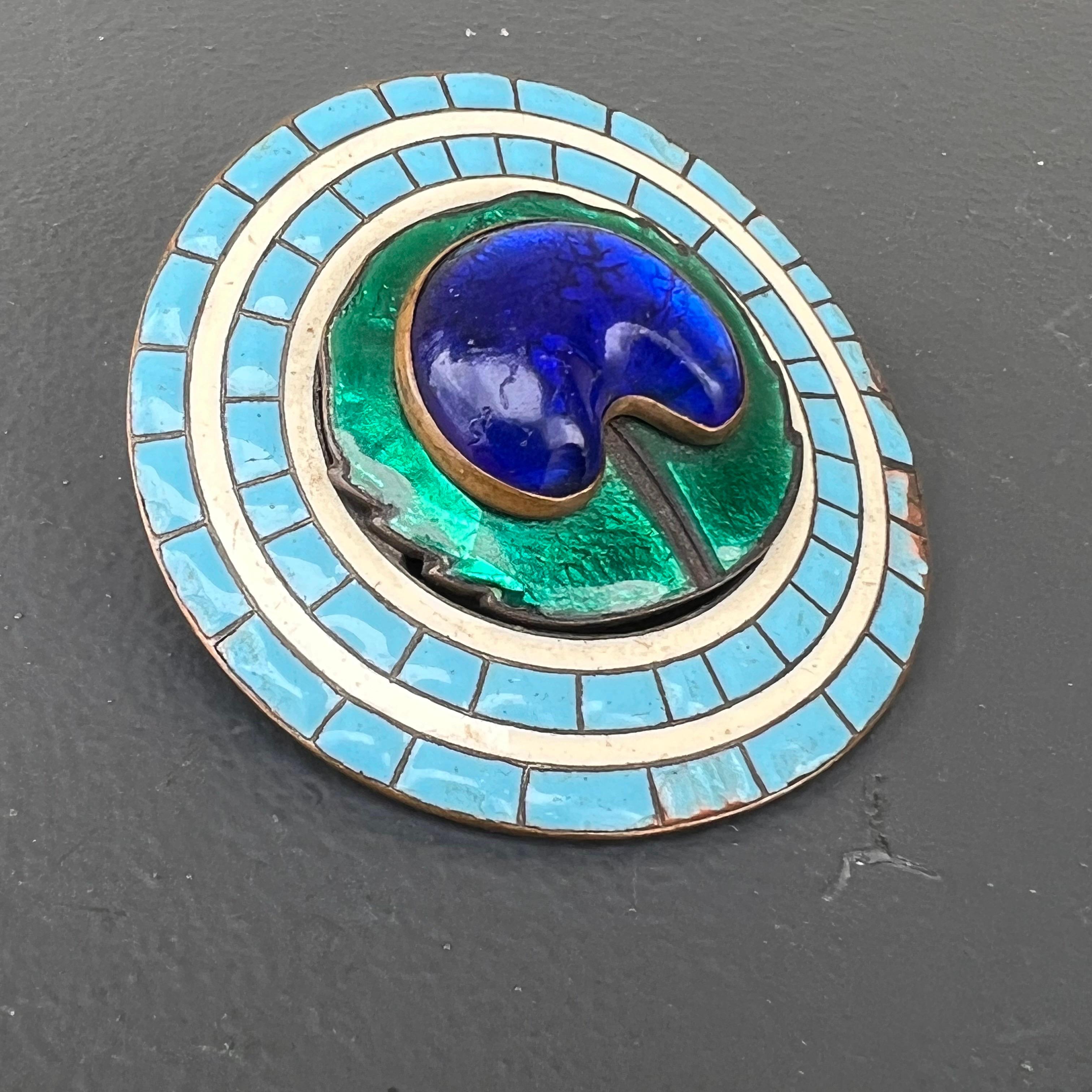 Large Antique Art nouveau Peacock eye Pin /brooch attributed to Piel Frères in Paris, France . Pin features  a central foil glass set on an what looks like copper as base metal with enamel work on front side.
Most likely pin is converted from an