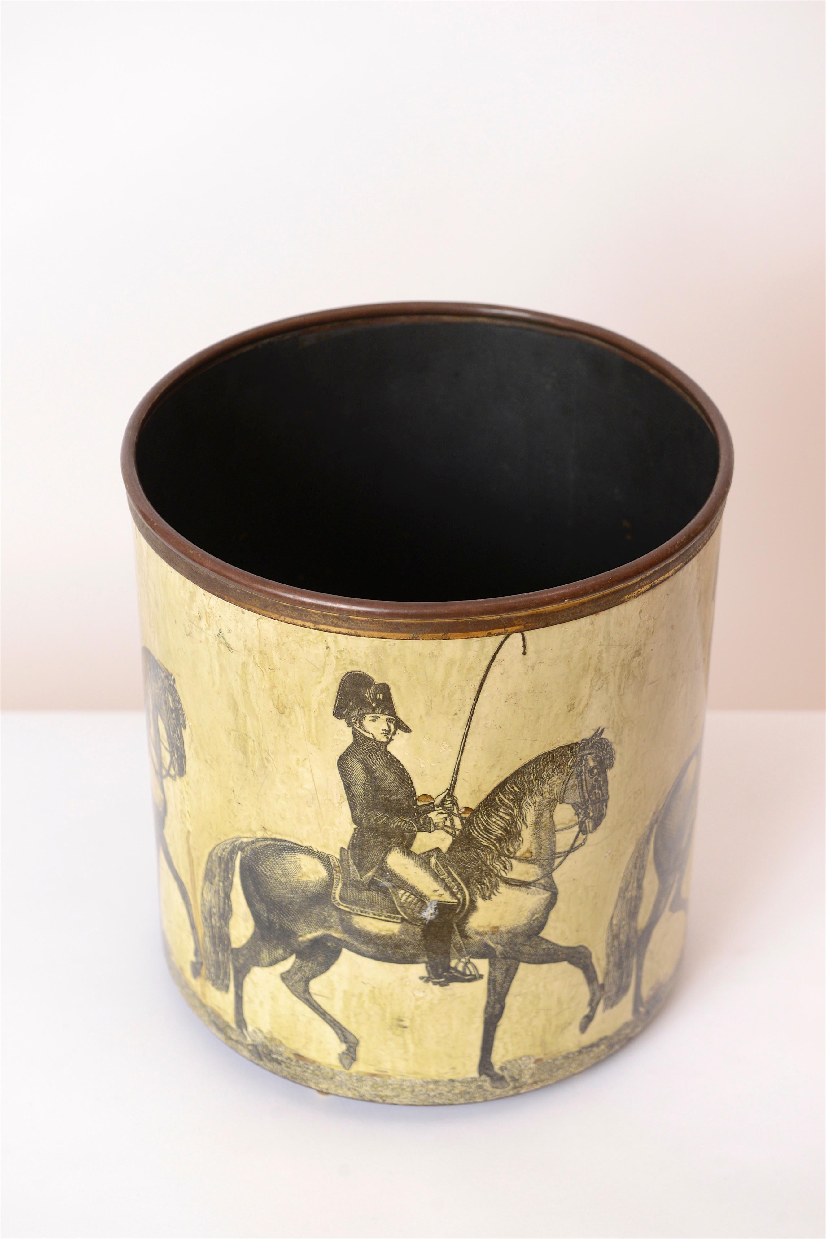 A rare ‘Cavalieri’ design waste paper basket by Piero Fornasetti, Italy, circa 1950. This early ‘Horsemen’ design depicts a uniformed man on horseback with whip. The lacquered hand-colored transfer images, along with the solid brass rim, have a