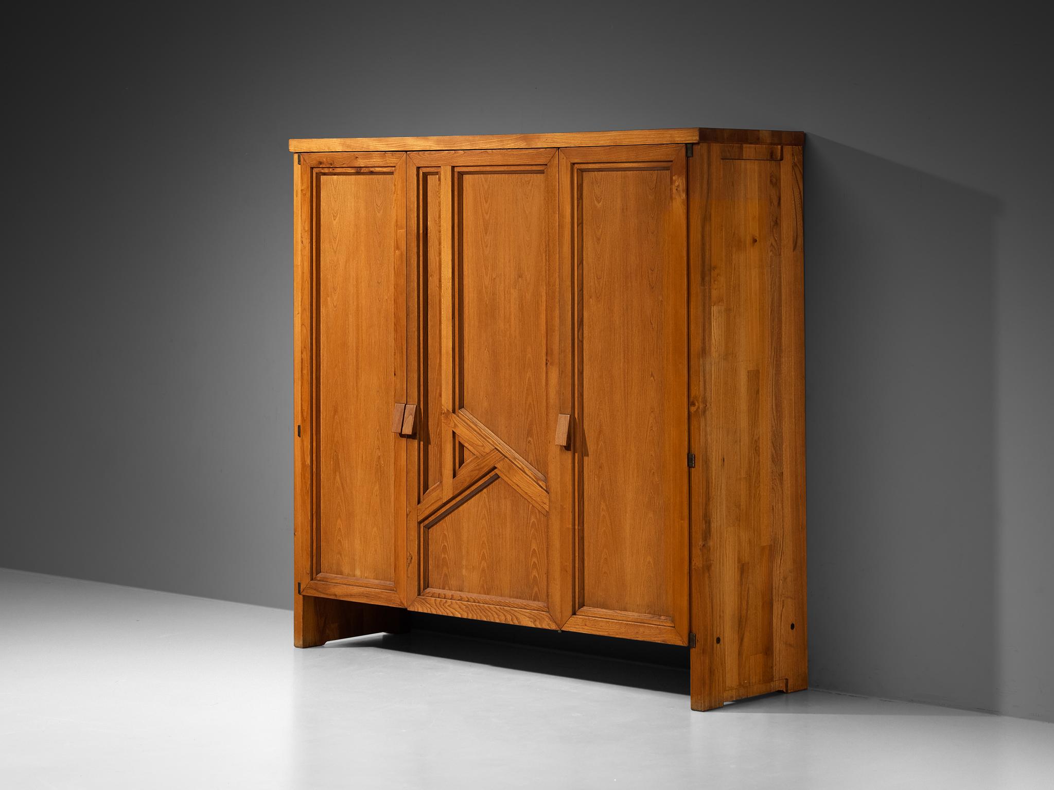 Pierre Chapo, 'Goya' wardrobe, model 'R26D', solid elm, mirrored glass, brass-plated steel, France, 1970s

An exceptional armoire designed by Pierre Chapo known as model 'Goya'. The door panels are beautifully constructed with a well-defined
