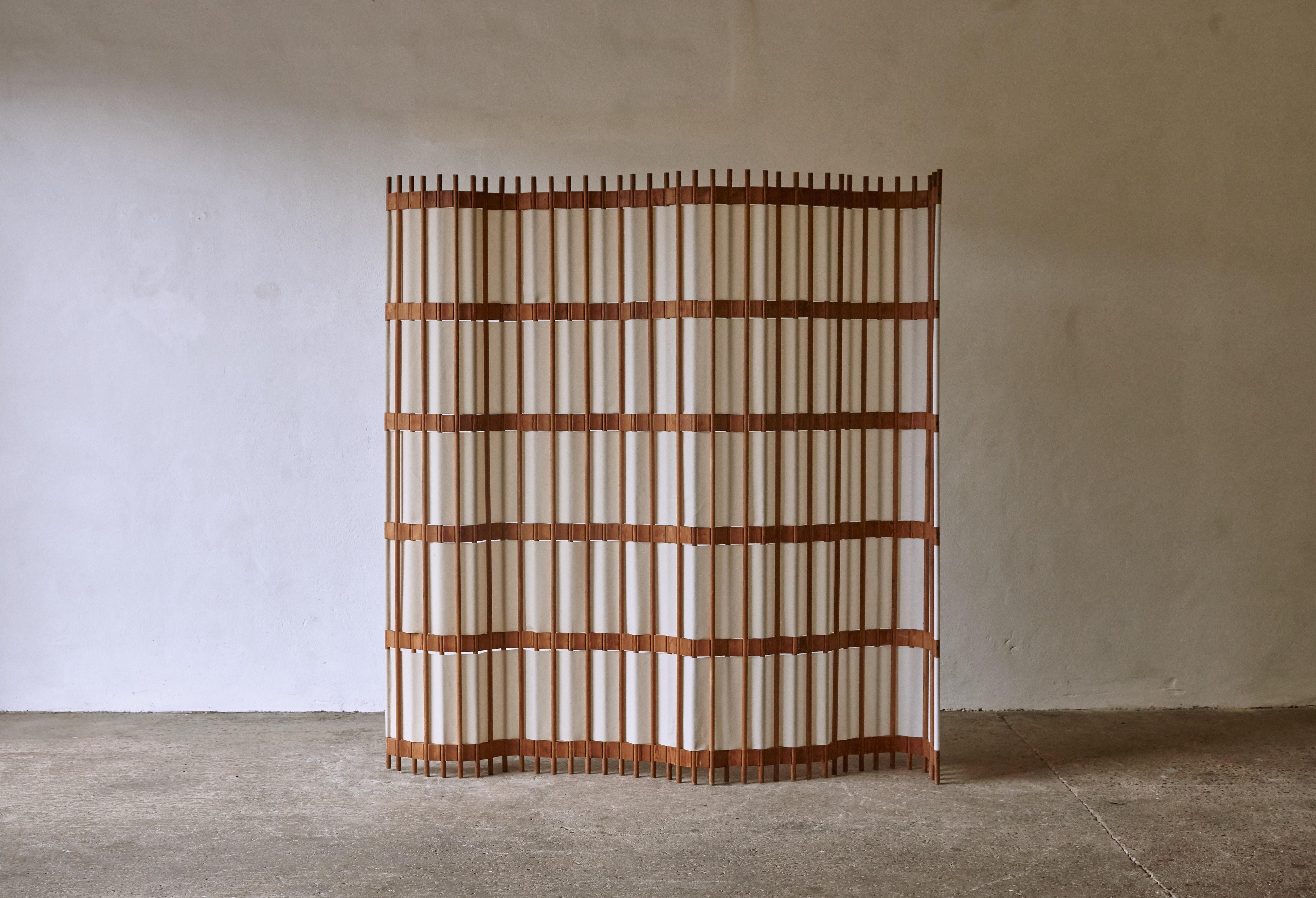 An extremely rare pine screen / room divider, Sweden, 1960s/70s. In good condition with minor signs of age and wear relative to age and use. The screen curves and bends and can be put in various positions. The material is a lampshade type material