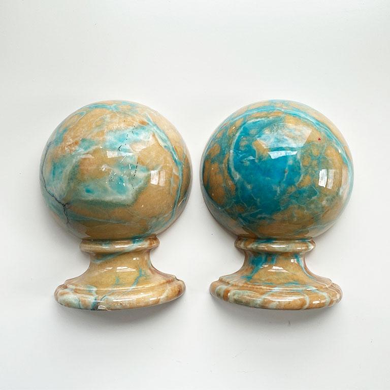 A beautiful and unusual pair of pink and blue globe shape bookends. Dust off that bookshelf and add something new. This pair is created from Italian alabaster and is a mix of bright azure blues and pinks. Each is flat on one side to hold up books,
