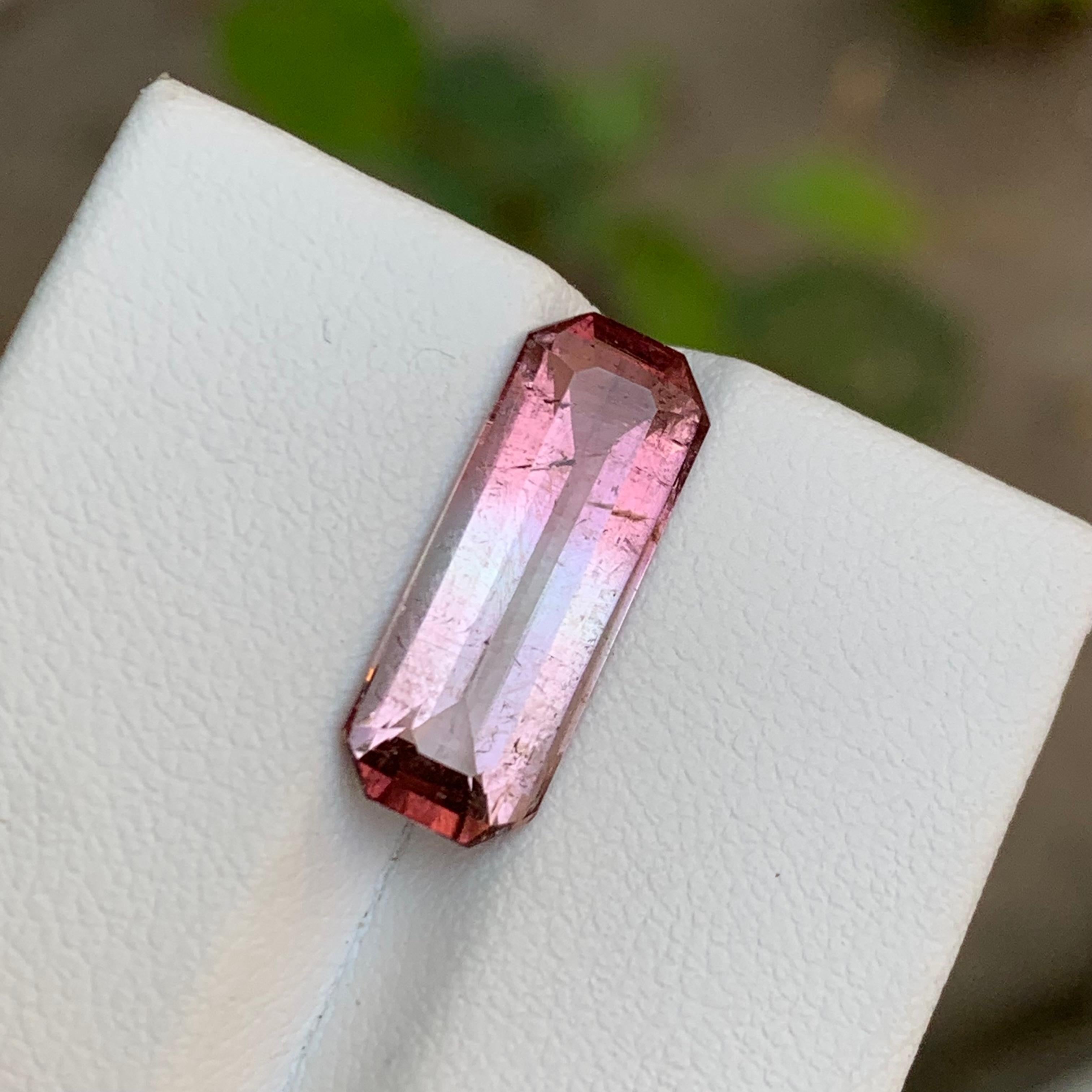 GEMSTONE TYPE: Tourmaline
PIECE(S): 1
WEIGHT: 4.90 Carats
SHAPE: Emerald 
SIZE (MM): 17.64 x 6.72 x 4.78
COLOR: Bicolor
CLARITY: Slightly included, with minor inclusions & Cracks that do not detract from the overall beauty and allure of the