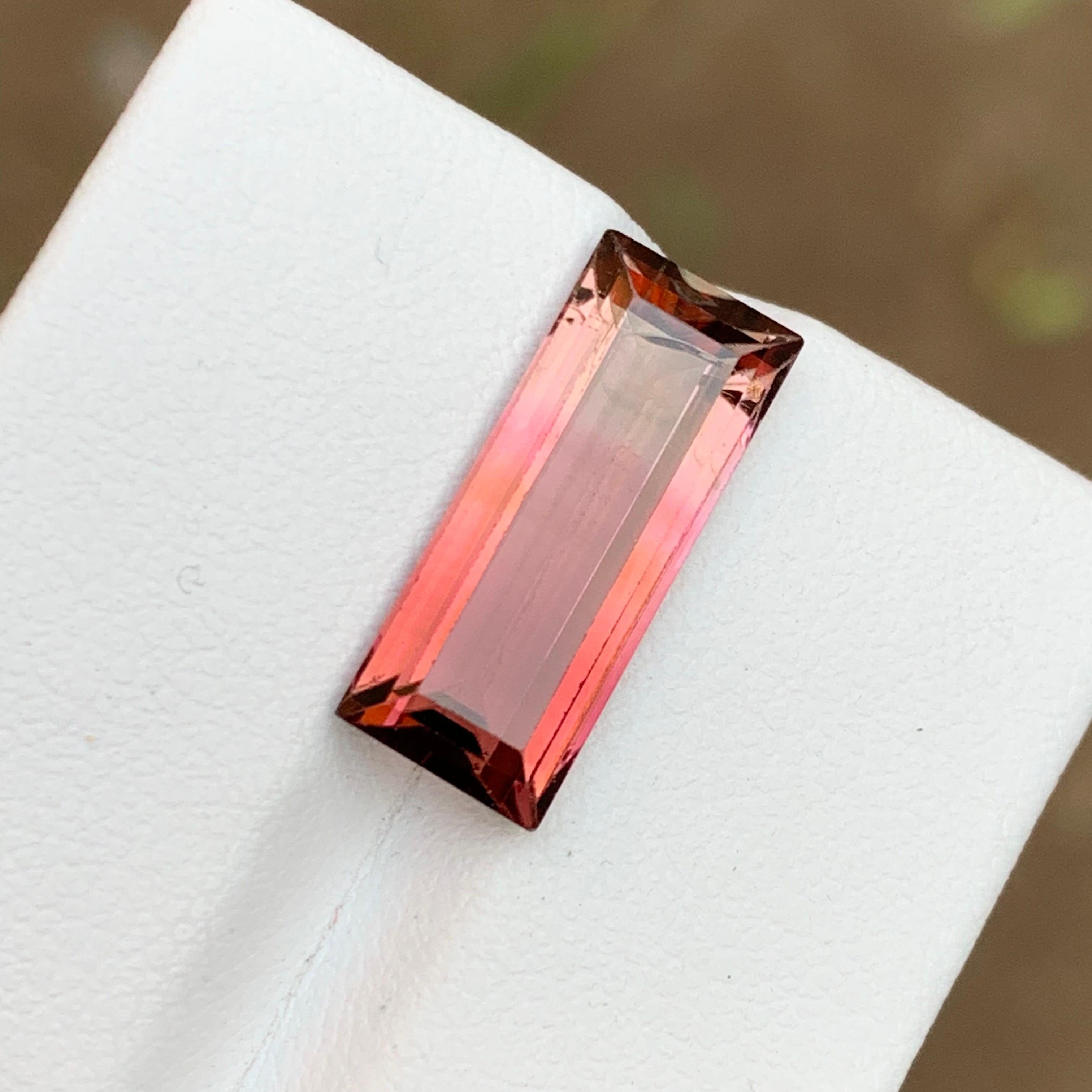 GEMSTONE TYPE: Tourmaline
PIECE(S): 1
WEIGHT: 6.40 Carats
SHAPE: Baguette 
SIZE (MM):  17.65 x 7.18 x 5.10 mm
COLOR: Pink Bicolor
CLARITY: 90% Eye Clean
TREATMENT: Heated
ORIGIN: Afghanistan 🇦🇫 
CERTIFICATE: On demand

This stunning 6.40 carat