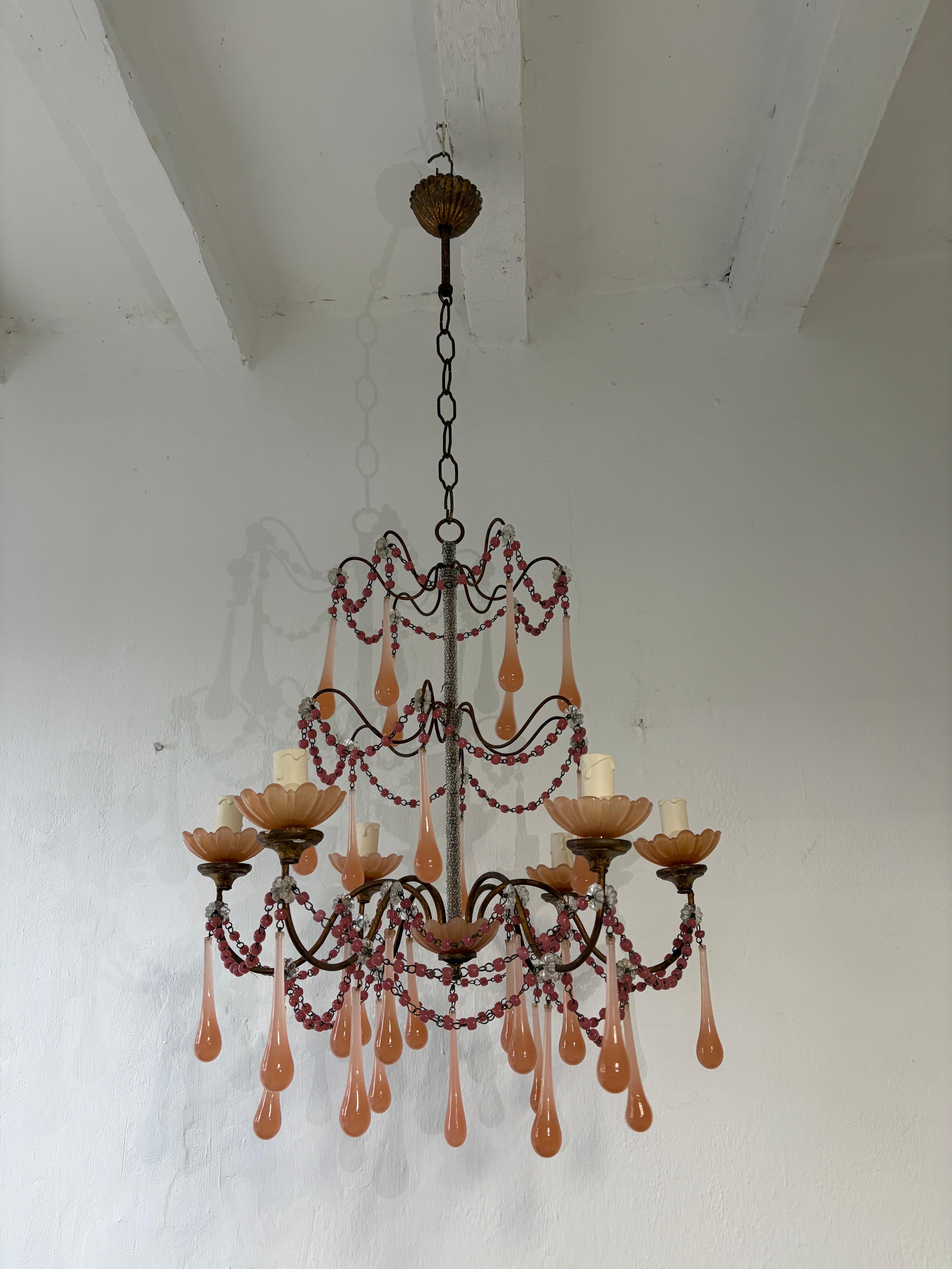 Housing 6 lights. Will be wired with certified sockets appropriate for country and ready to hang. (UL US for the USA) Lights sitting in pink opaline bobeches on top of  gilt wood posts. Swags of pink opaline macaroni beads and clear florets.