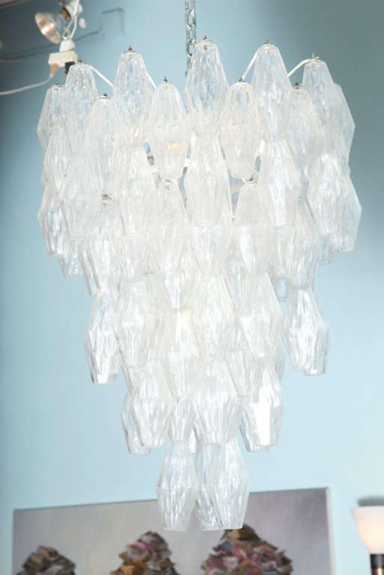 Designed by Paolo Venini and originally introduced in 1957. Beautiful and large fixture with textured blown glass. Abstract diamond forms with faceted sides hanging from multi-armed interior frame, with 14 candelabra sockets. *2nd matching fixture