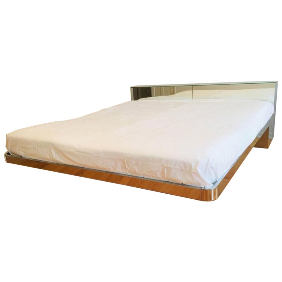 Stunning, and very rare sleek postmodern elegant designer chrome and mirrored King platform bed by O.B. Solie for ELLO furniture. Ello is a very famous company from the 80s that created very limited edition cult mirrored furniture, and it is now