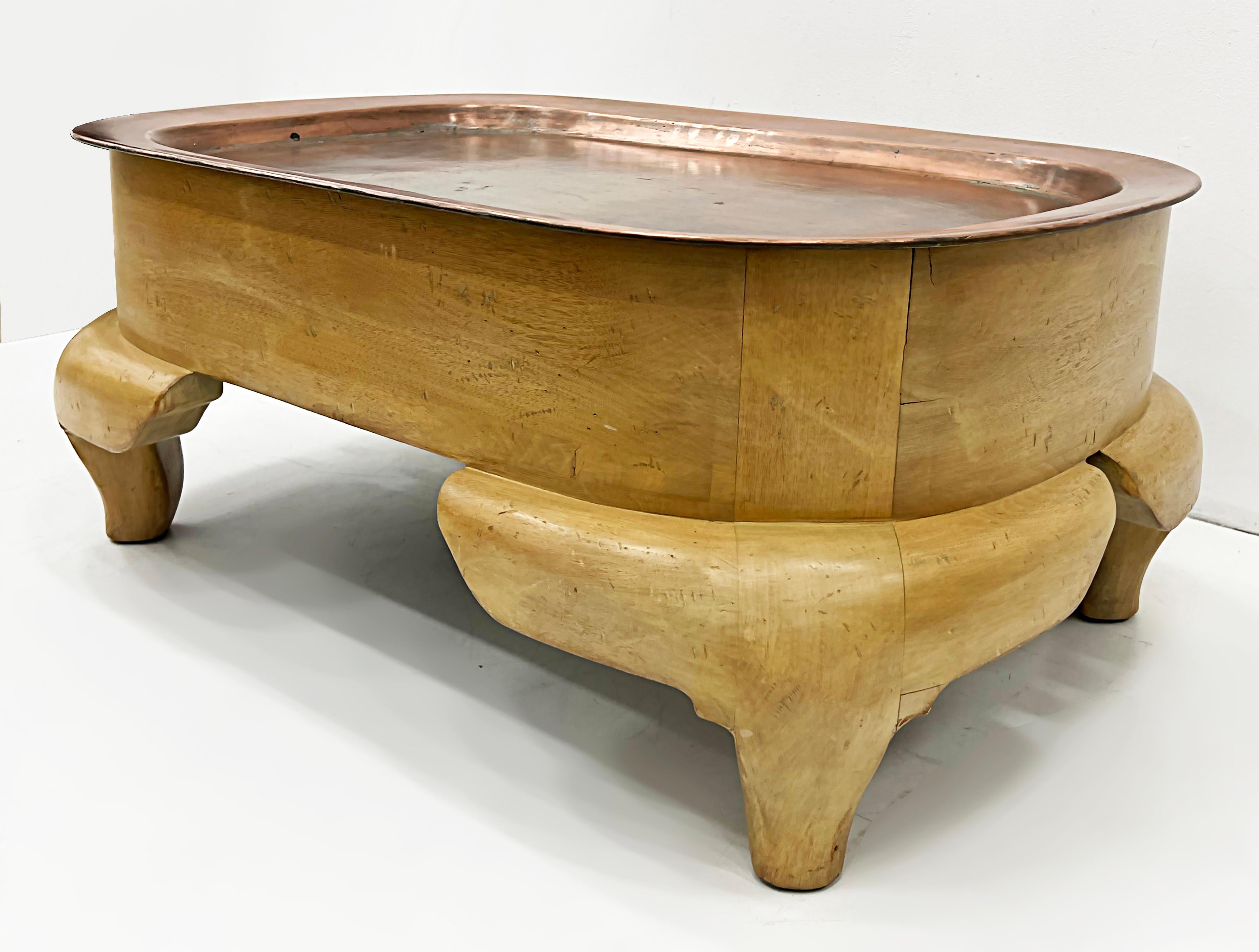 Rare Postmodern wood coffee table with a copper tray top

Offered for sale is a very rare and unusual blonde Postmodern wood coffee table with a large and substantial copper tray top. This stylized table is in vintage condition with a rich-aged