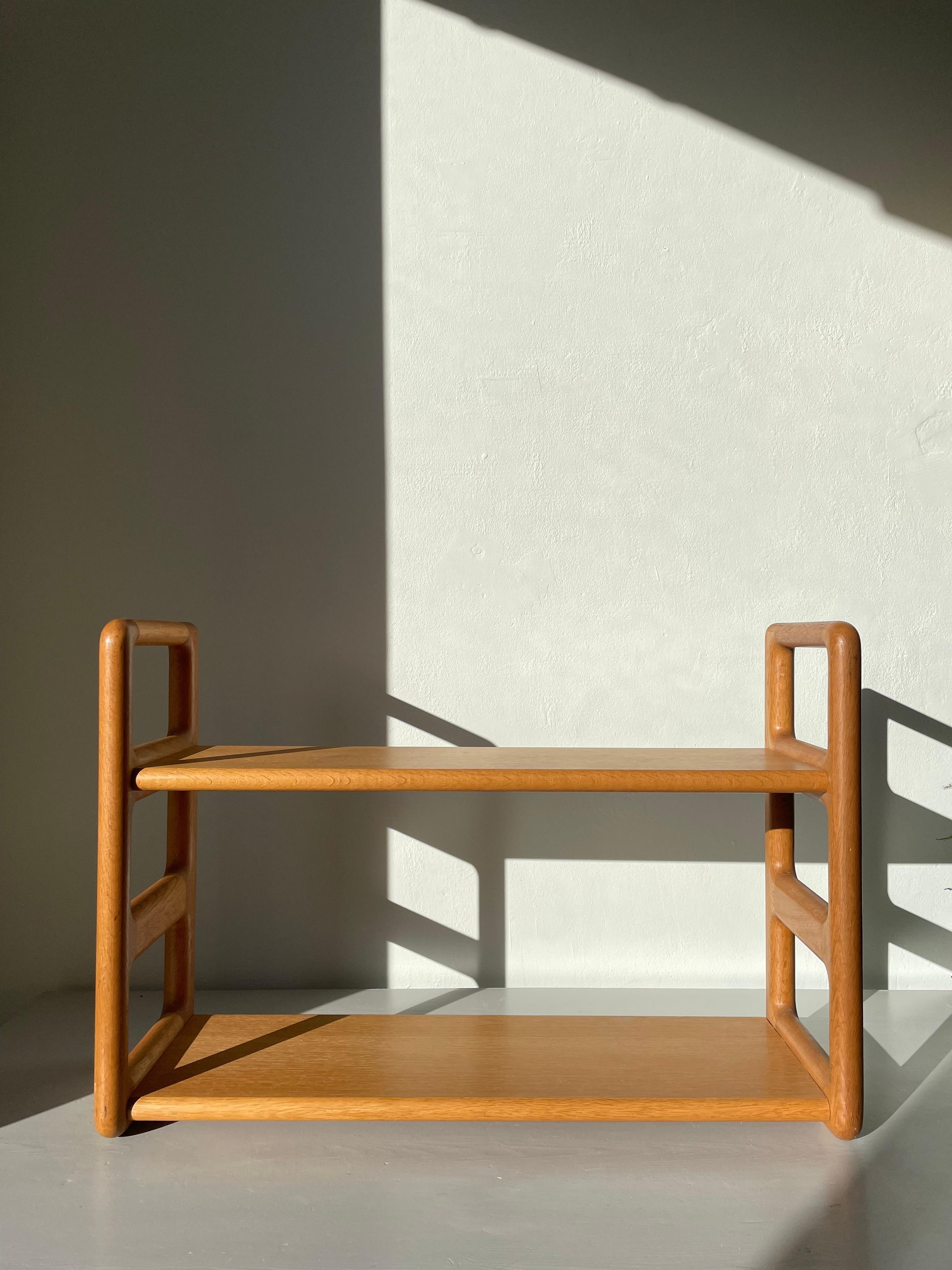 Rare handmade solitary teak wall unit with two shelves designed by acclaimed Danish designer Poul Cadovius in the 1960s. Solid smoothly rounded wooden brackets on which two shelves are attached. Simple and functional modernist design. Metal mount on