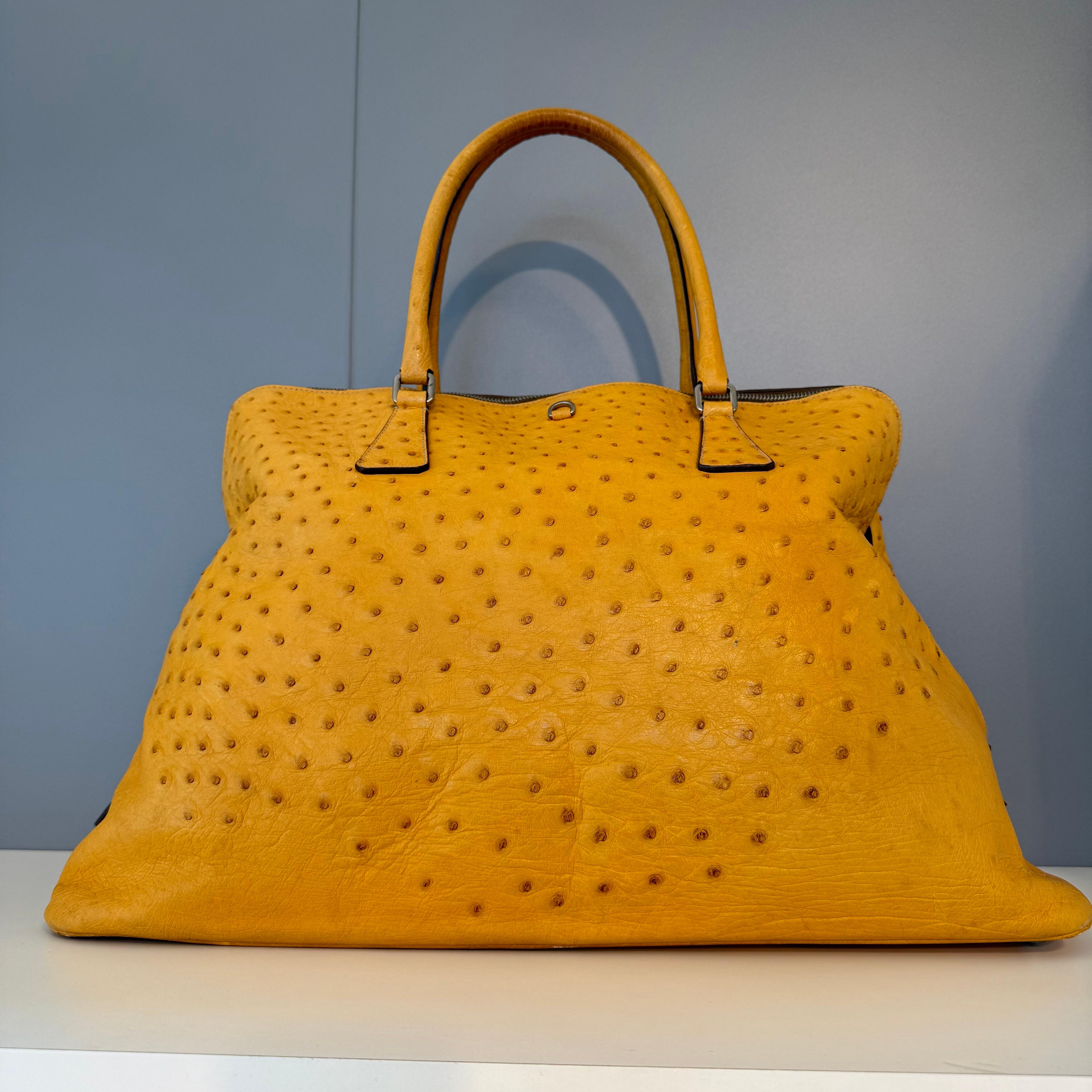 Extremely rare and sought after Prada bag
Real ostrich leather
Yellow ocher color 
Two handles 
Zip closure 
With locker and keys 
Internal zip pocket 
Internal textile 
Cm 50 x 32 x 21 (19.6 x 12.5 x 8.2 inches)
Worldwide express shipping included