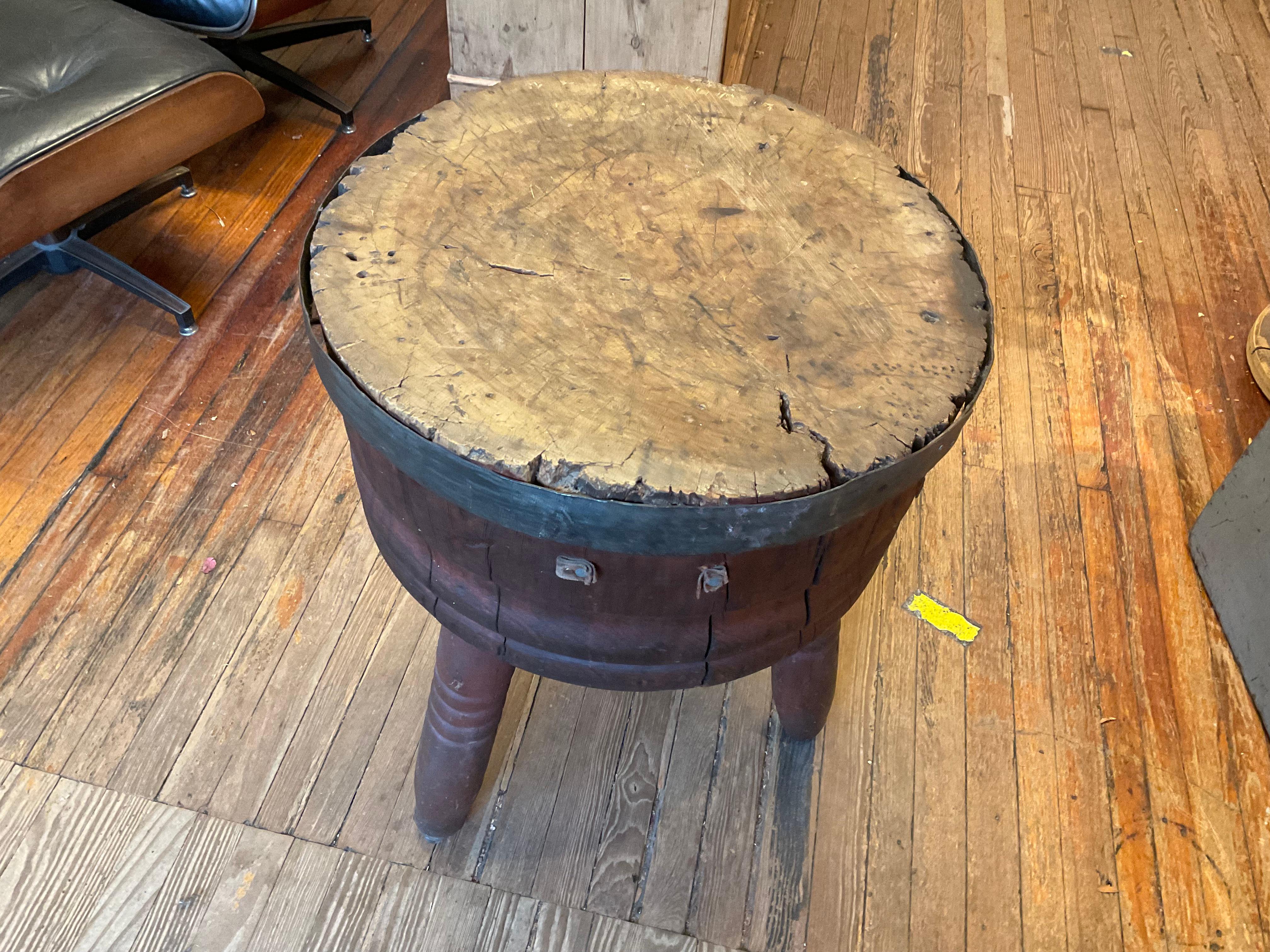Rare primitive round side table having wine barrel shaped base with distressed wood and metal bands on turned legs.  The top is a fantastically weathered solid piece of burled butcher block with irregular edges.
