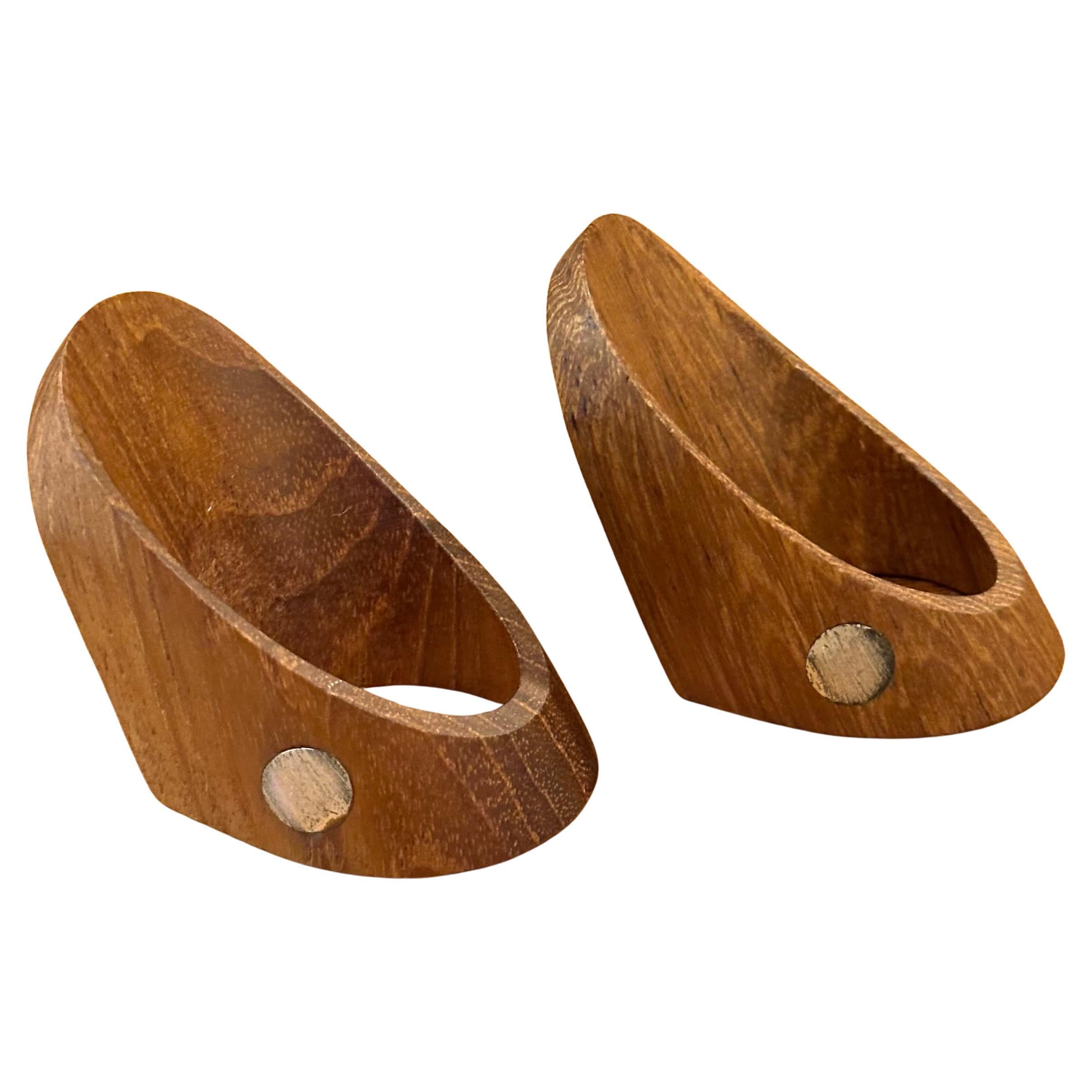 Rare prototype set of two teak Danish modern napkin rings by Danish furniture designer, J. Kjaersulf, circa 1966.  This unique and one of a kind solid teak napkin rings are decorated with a brushed sterling silver dot and were exhibited at the