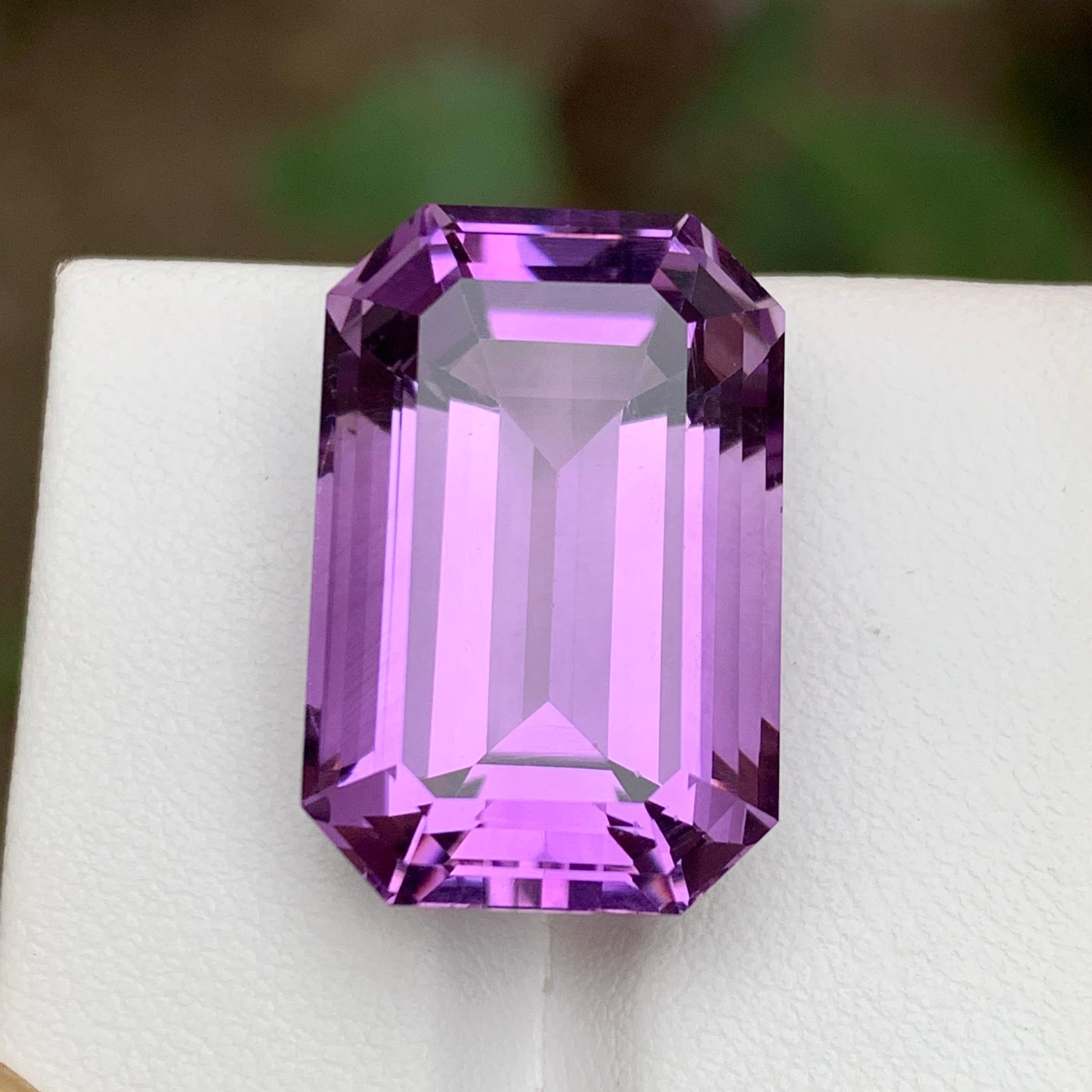 GEMSTONE TYPE: Amethyst 
PIECE(S): 1
WEIGHT: 27.30 Carats
SHAPE: Step Emerald Cut
SIZE (MM): 21.79 x 14.32 x 11.82
COLOR: Purple
CLARITY: Eye Clean
TREATMENT: None
ORIGIN: Africa
CERTIFICATE: On demand
(if you require a certificate, kindly request