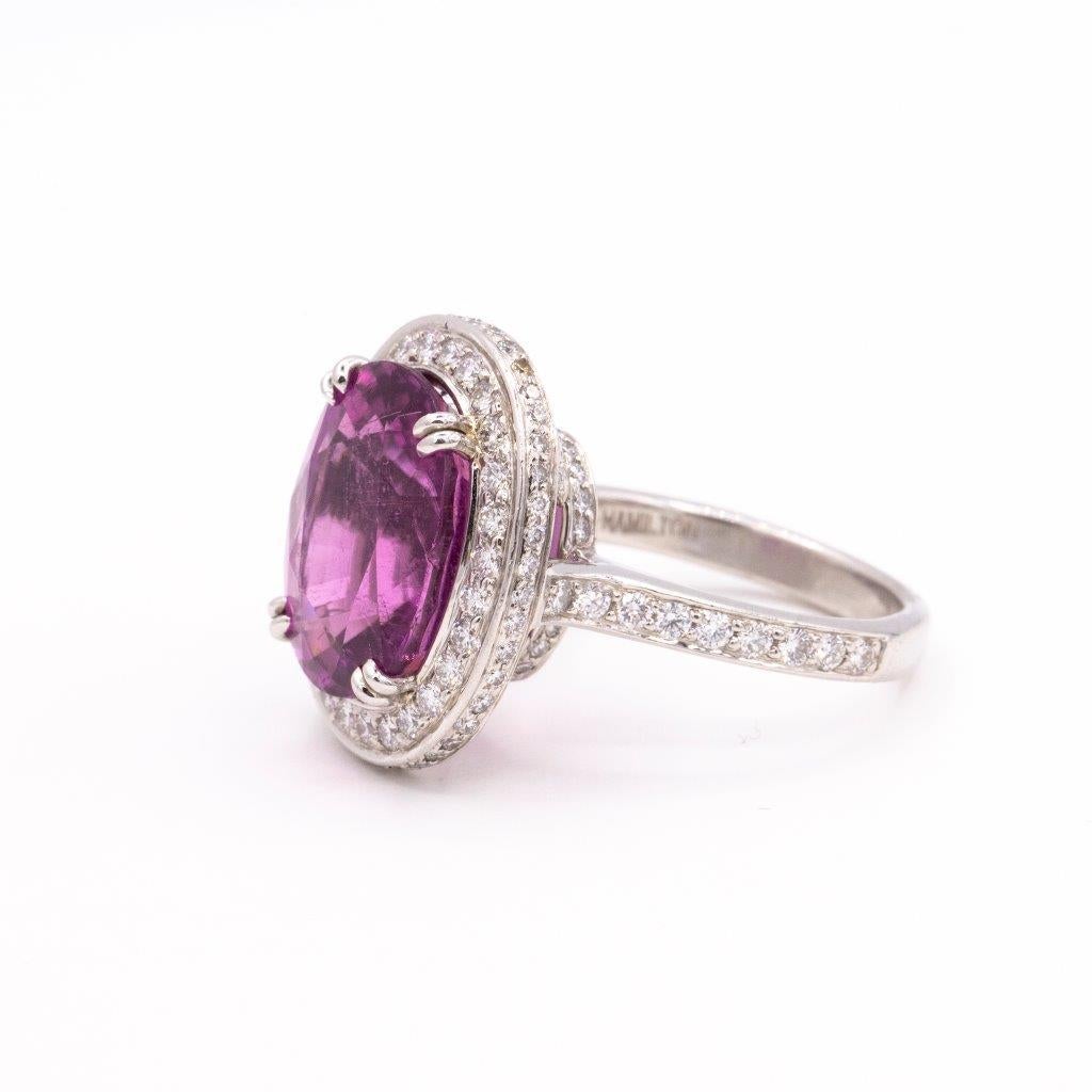 Stunning 8.49 carat rare purple-pink oval tourmaline gemstone ring with pave diamond halo and diamond set in the shank and under carriage. Diamonds weigh 1.10 carats. Crafted in precious platinum.