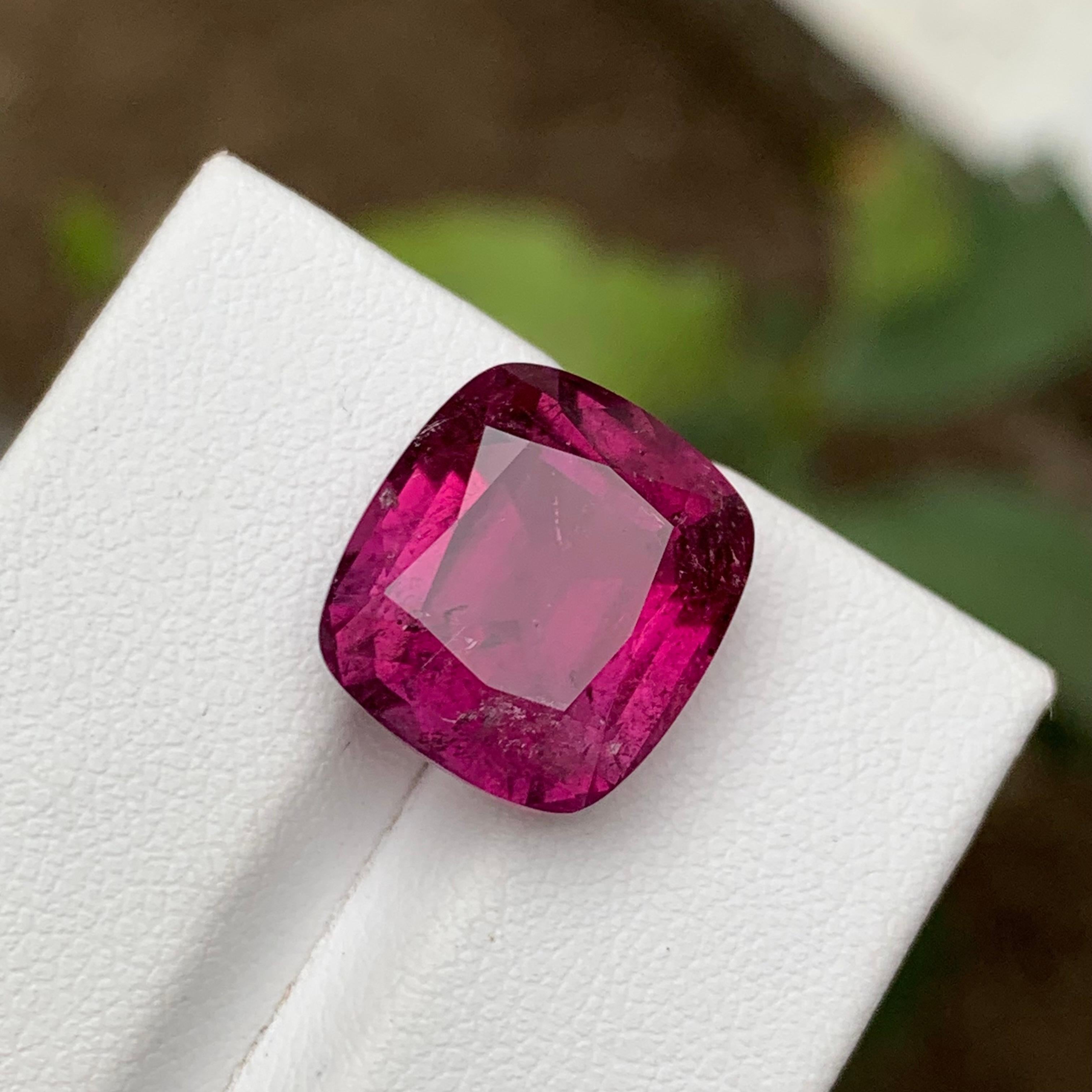 GEMSTONE TYPE: Rubellite Tourmaline
PIECE(S): 1
WEIGHT: 11.05 Carats
SHAPE: Cushion 
SIZE (MM): 14.17 x 12.80 x 8.32
COLOR: Purplish Pink
CLARITY: Moderately Included 
TREATMENT: Heated
ORIGIN: Afghanistan
CERTIFICATE: On demand

Introducing our