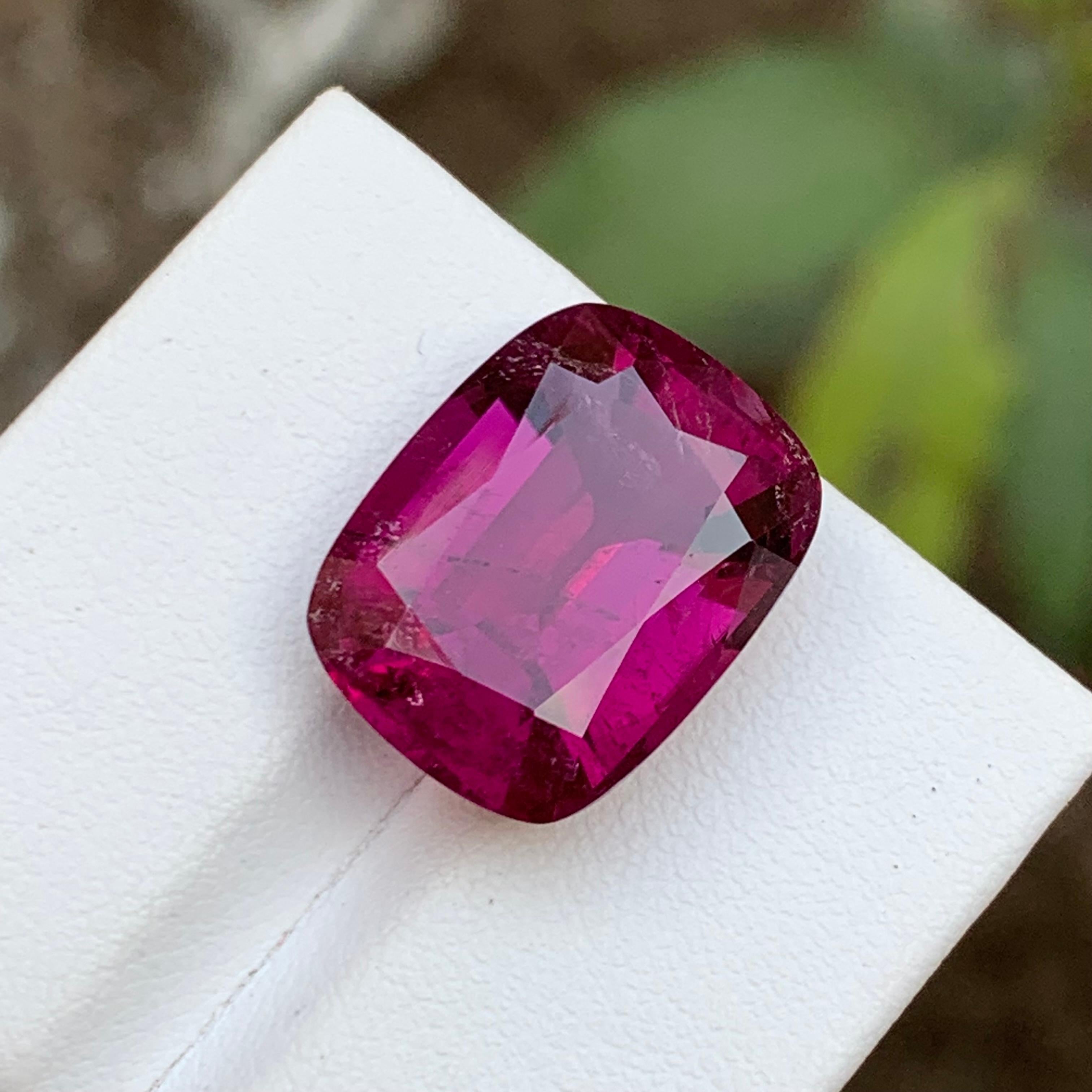 GEMSTONE TYPE: Rubellite Tourmaline
PIECE(S): 1
WEIGHT: 13.45 Carats
SHAPE: Cushion 
SIZE (MM): 17.06 x 13.07 x 8.24
COLOR: Purplish Pink
CLARITY: Moderately Included 
TREATMENT: Heated
ORIGIN: Afghanistan
CERTIFICATE: On demand

Introducing our