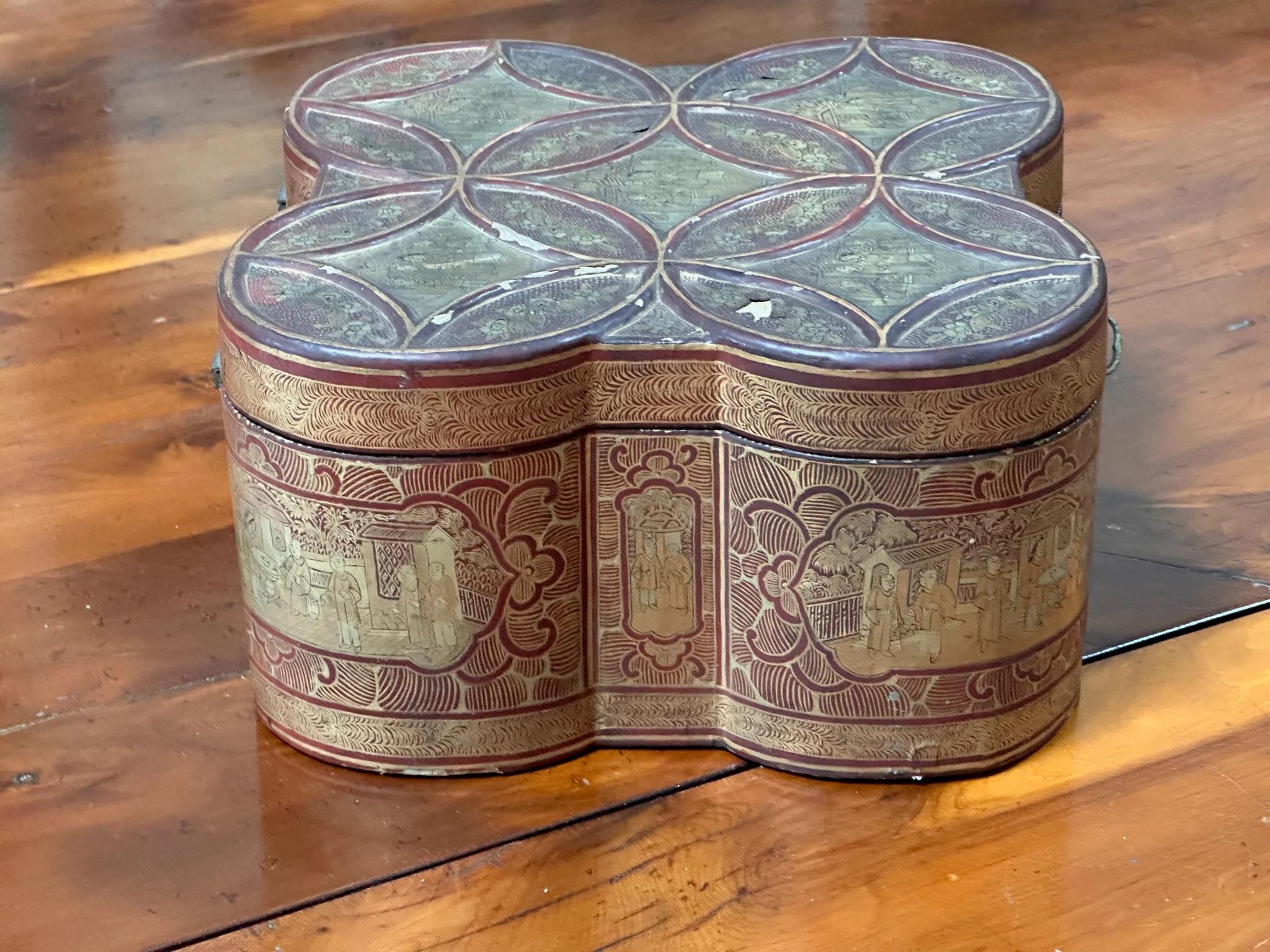 Rare quatrefoil Chinese Export Tea Caddy, 19th Century, the lacquer tea caddy with interlocking circles design, in deep red, black, and gilt with internal pewter container with bone handle, engraved top surface, lock and key..  
