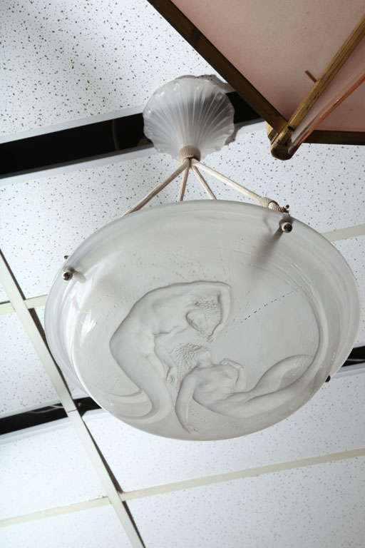 René Lalique,
“Deux Sirenes” chandelier no. 2452, design created 1921. In clear and frosted glass molded with two mermaids swimming gracefully. Measures: Diameter 15.6 in., drop 23