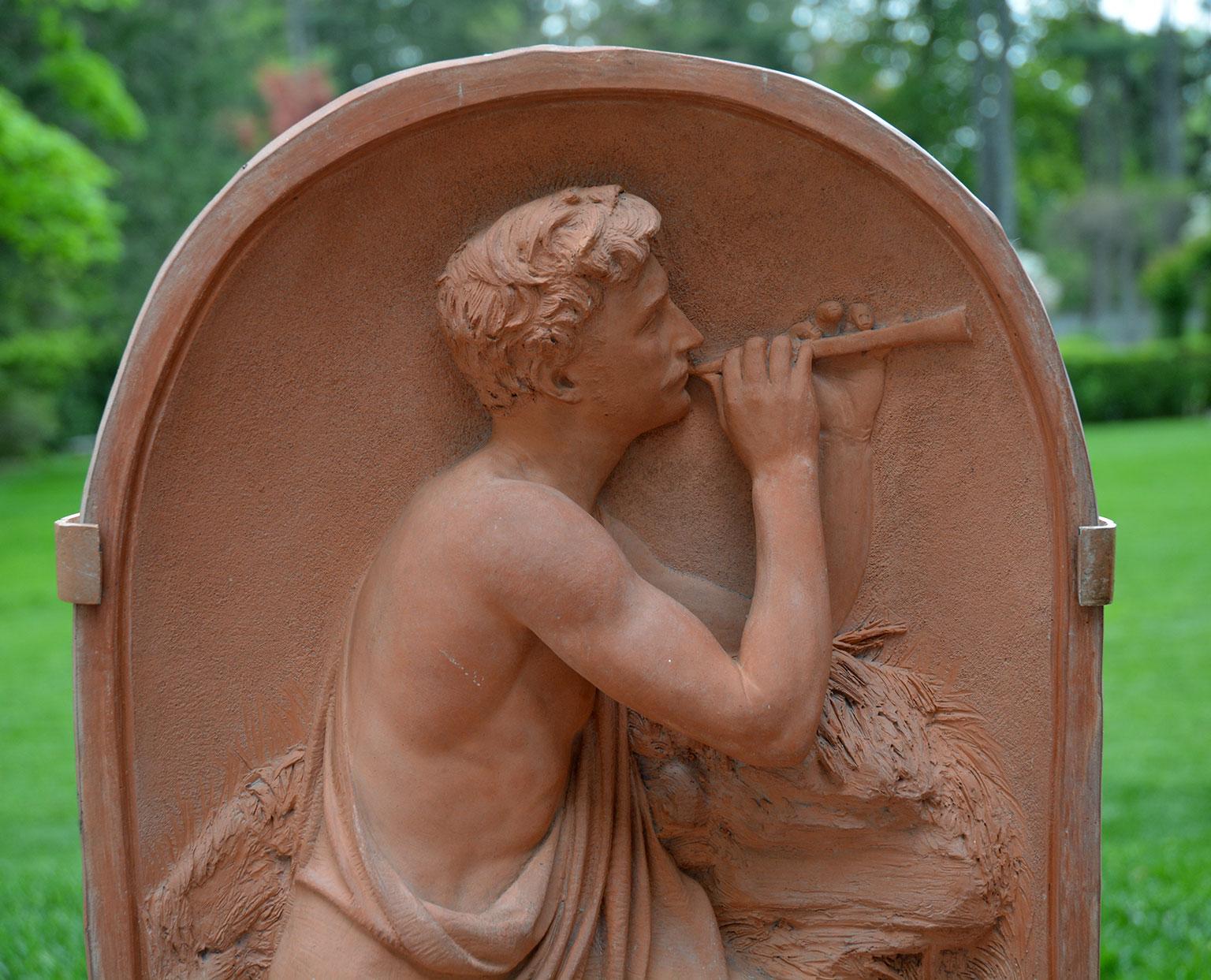 A rare terracotta plaque by Robert Wallace Martin (1843-1923) depicting a male shepherd in a rocky landscape and playing a pipe, the plaque incised “R Wallace Martin 1871-2 Sc B4 3, and impressed “R.W.M.”, English, 1871-2, 26.25 ins. high, 13 ins.