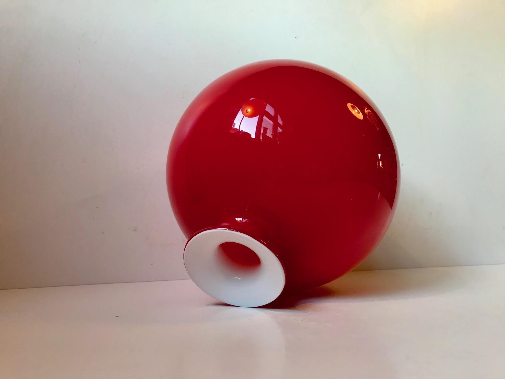 Monumental red cased hand blown opaline glass vase designed by Per Lütken in 1969 and manufactured by Holmegaard in Denmark until 1976. This color and size in particular in the Carnaby/Palet series is the rarest.