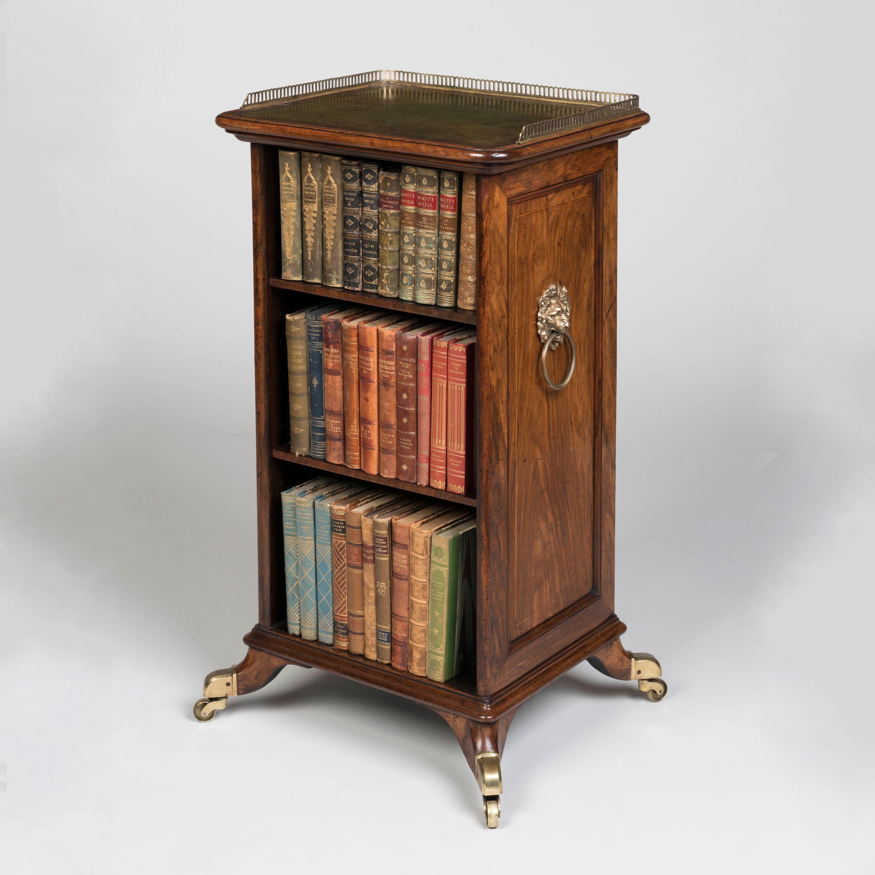 A Rare Regency Period Free-Standing bookcase

Constructed from walnut, supported on brass castors and splayed legs, with one open side fitted with two shelves; the back fitted with a brass grille and silk fabric dustcover while the sides are