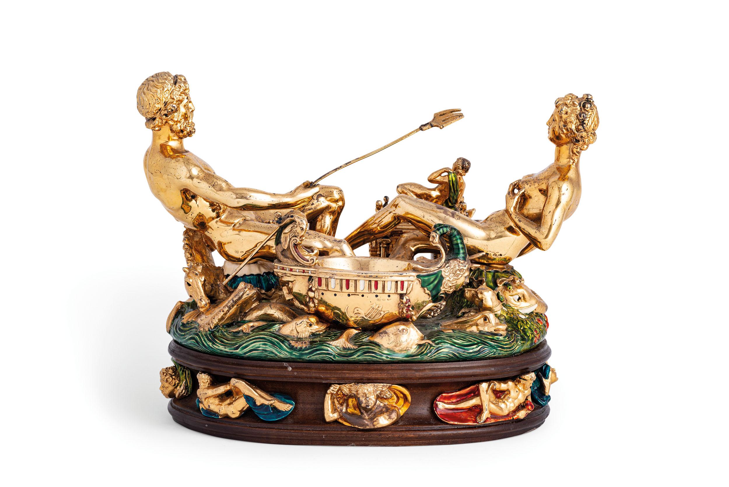 Rare replica of Benvenuto Cellini’s Renaissance Salt Cellar for Francis I

Produced by Morpier Argenteria; after Benvenuto Cellini
Florence, Italy; 1970’s
Gilt silver, enamel, resin and wood

Approximate size:  10.6 (h) x 13.75 (w) x 8.5 (d) in.

A