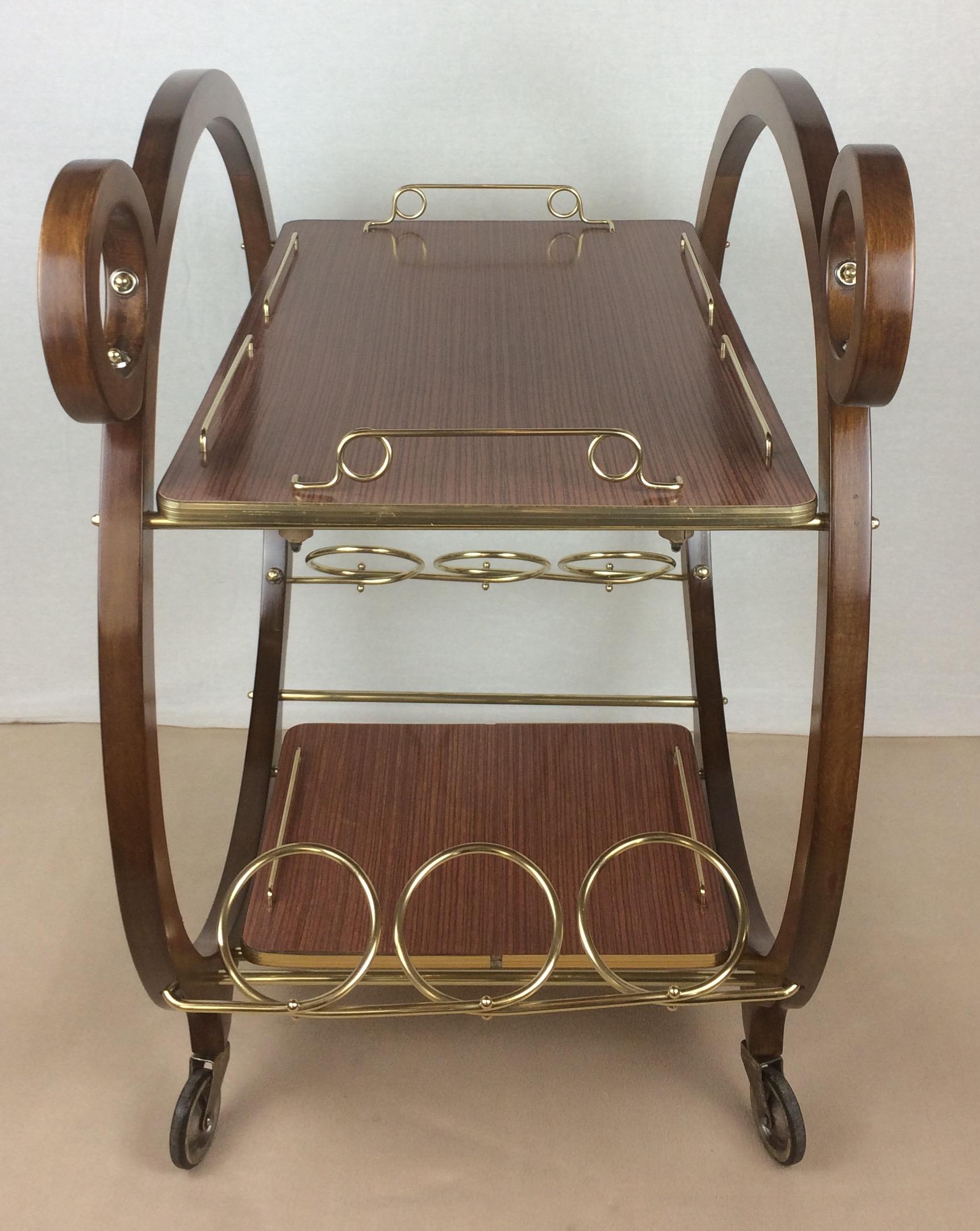 A rare French bar cart or drinks trolley restored to perfection.  Designed by La Maison Dinett of Paris, France, circa 1940s. Unique wooden round frame featuring gorgeous details.  The birch wood makes this piece very strong. 

There are 6 bottle