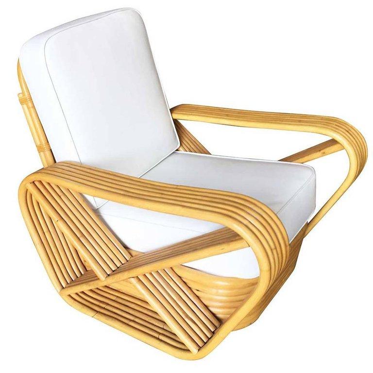 Designed in the manner of Paul Frankl, this five-strand, rattan lounge chair features square pretzel arms and a classic stacked base.

New Custom or Original Cushions in White Naugahyde or C.O.M. (Customers Own Material) are included in the price.