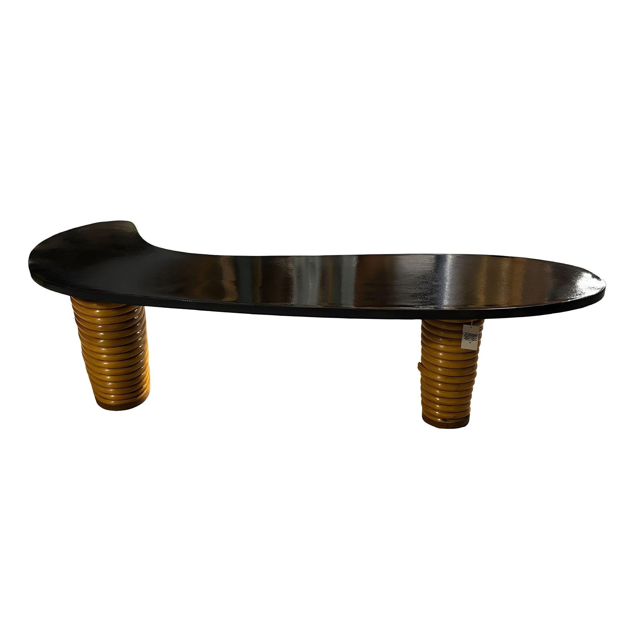 Rare restored rattan L-shaped Amoeba coffee table with glossy black lacquer style top and 2 stacked legs The stacked rattan legs offer sturdy support and an eye-catching design that complements any décor. Perfect as a centerpiece for your living