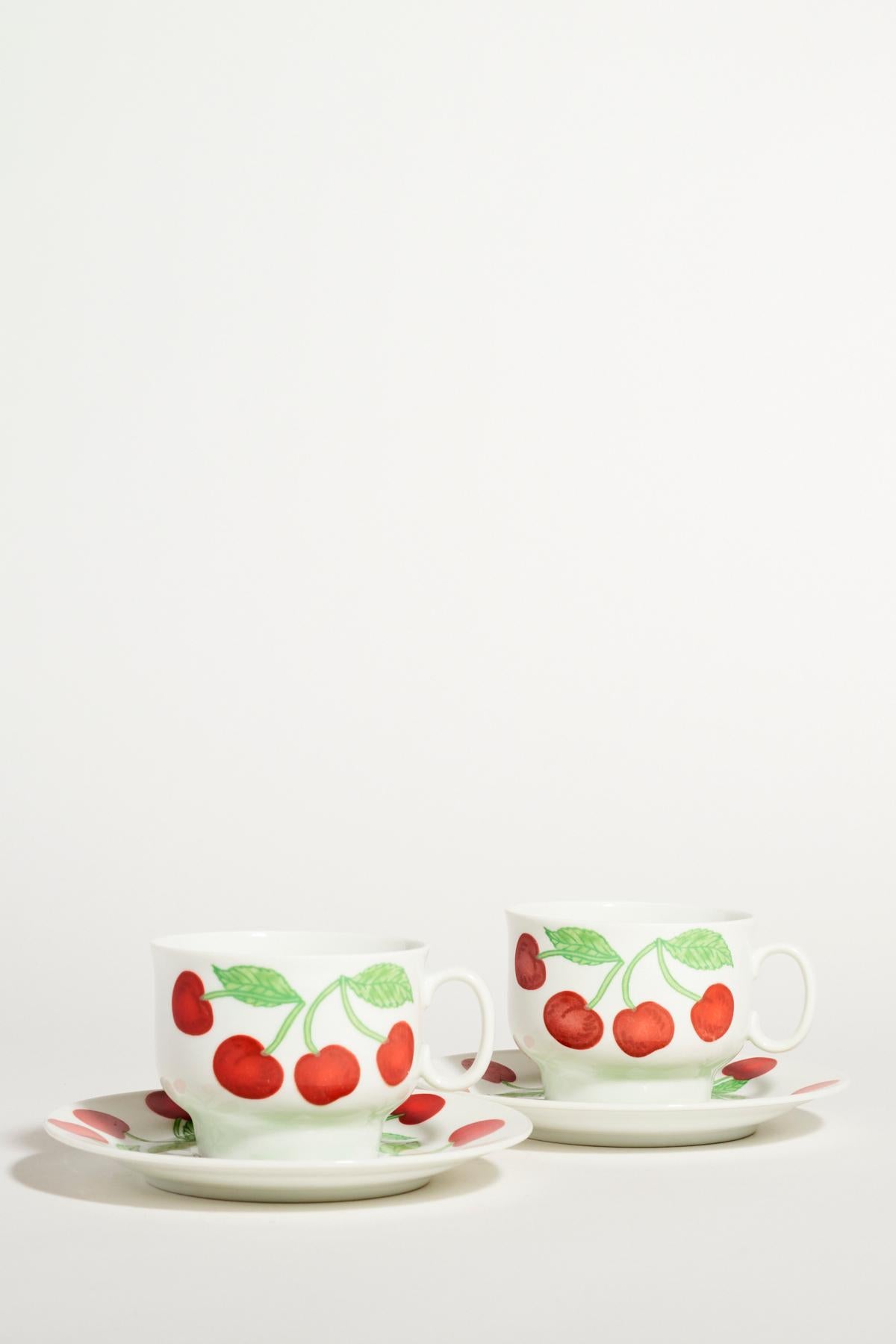 Richard Ginori quality porcelain coffee set of six, bright cherry motif against a crisp white background.