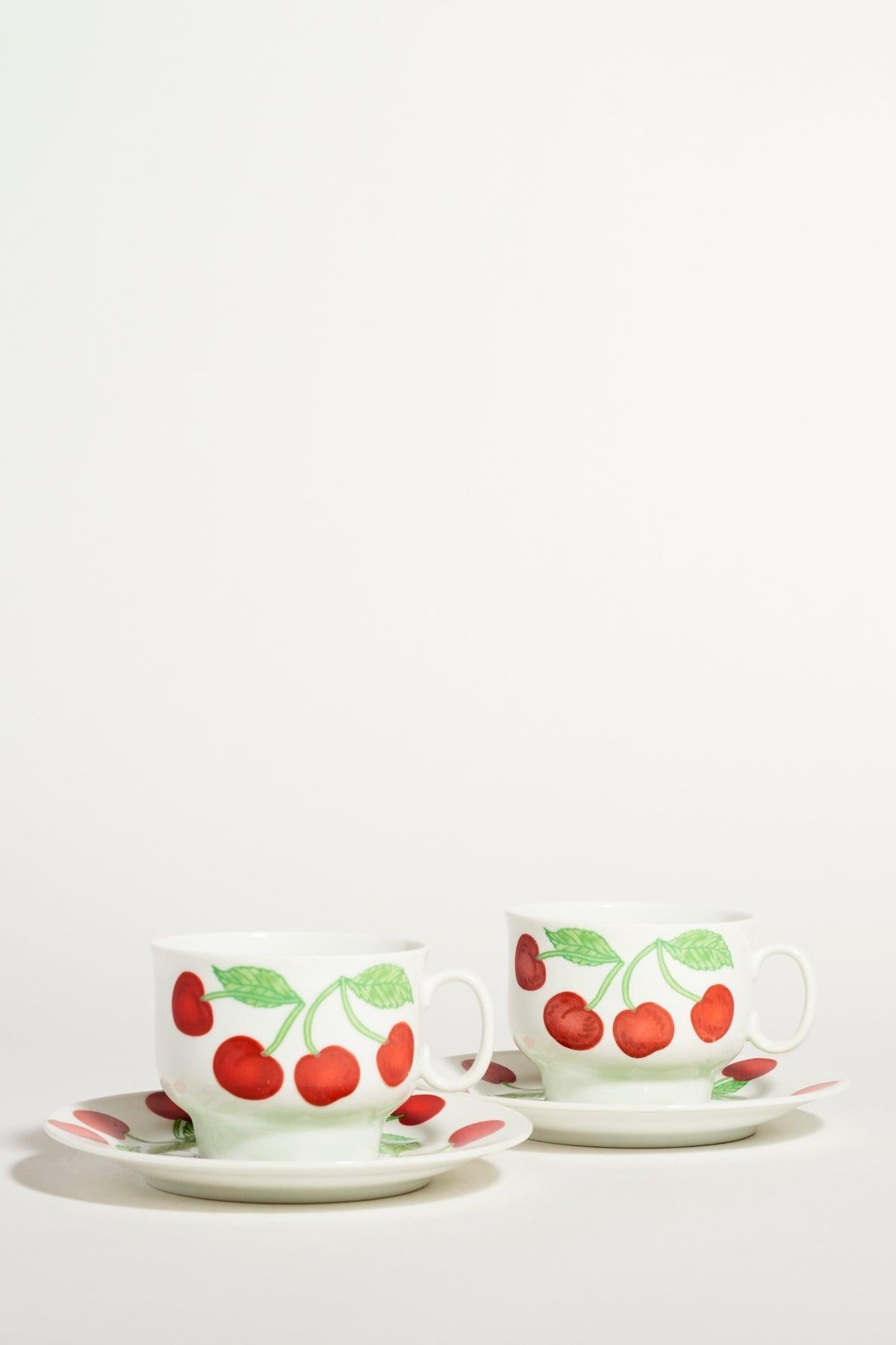 Richard Ginori quality porcelain coffee set of two, bright cherry motif against a crisp white background.