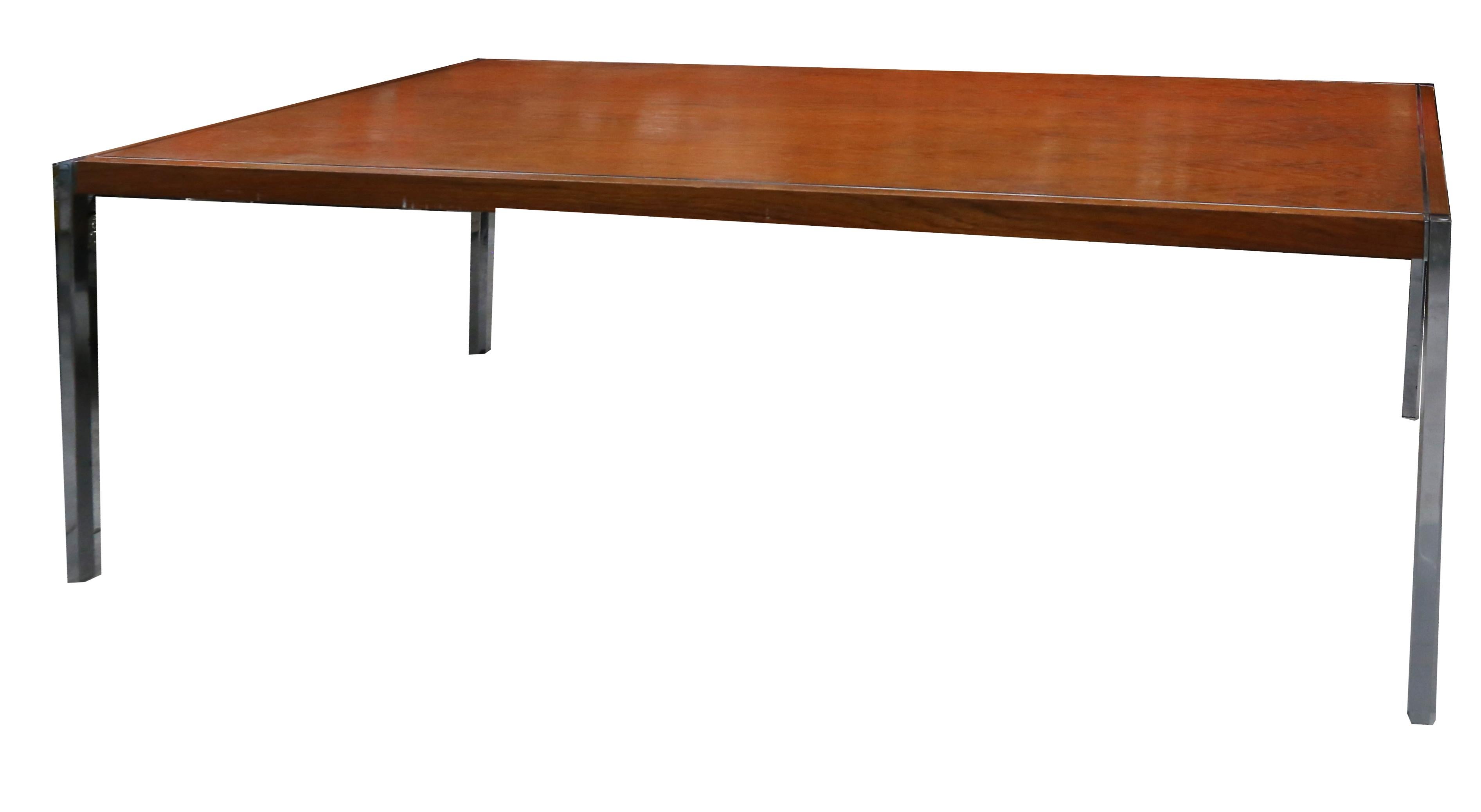 Richard Schultz dining table/ desk with rosewood top and polished stainless steel legs by Knoll.
The table has inlaid stainless detail along edges.