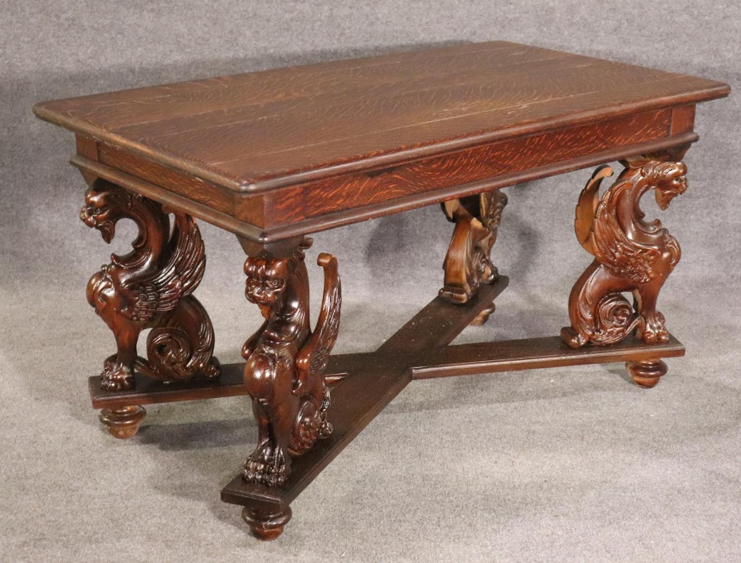 This is a gorgeous oak griffin writing table with gorgeous tiger oak gorgeous design and proportions. Could also be used as a center table in a foyer. Carved. Griffin detail. 30 1/4