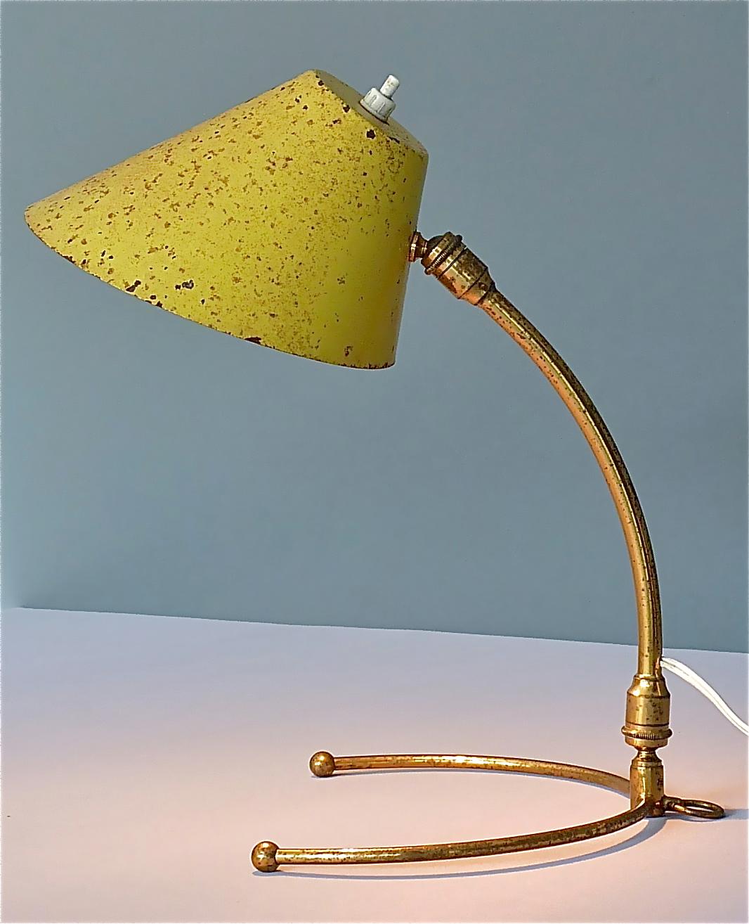 Super rare midcentury table / wall lamp by Robert Mathieu and most probably in cooperation with Pierre Guariche, designed and manufactured in France, circa 1950s. A yellow enameled aluminum metal shade with integrated switch and brass bajonet