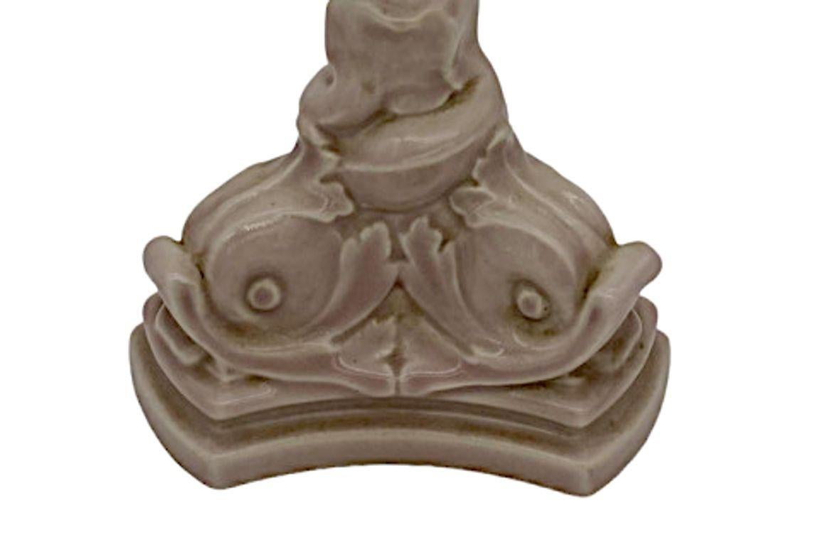 Rockwood Pottery McDonald NU 2464 Light Pink Dolphin Candlesticks by Lucile Henzke:

These enchanting candlesticks embody the collaborative brilliance of Rockwood Pottery and the artistic touch of Lucile Henzke. Adorned with the distinctive McDonald