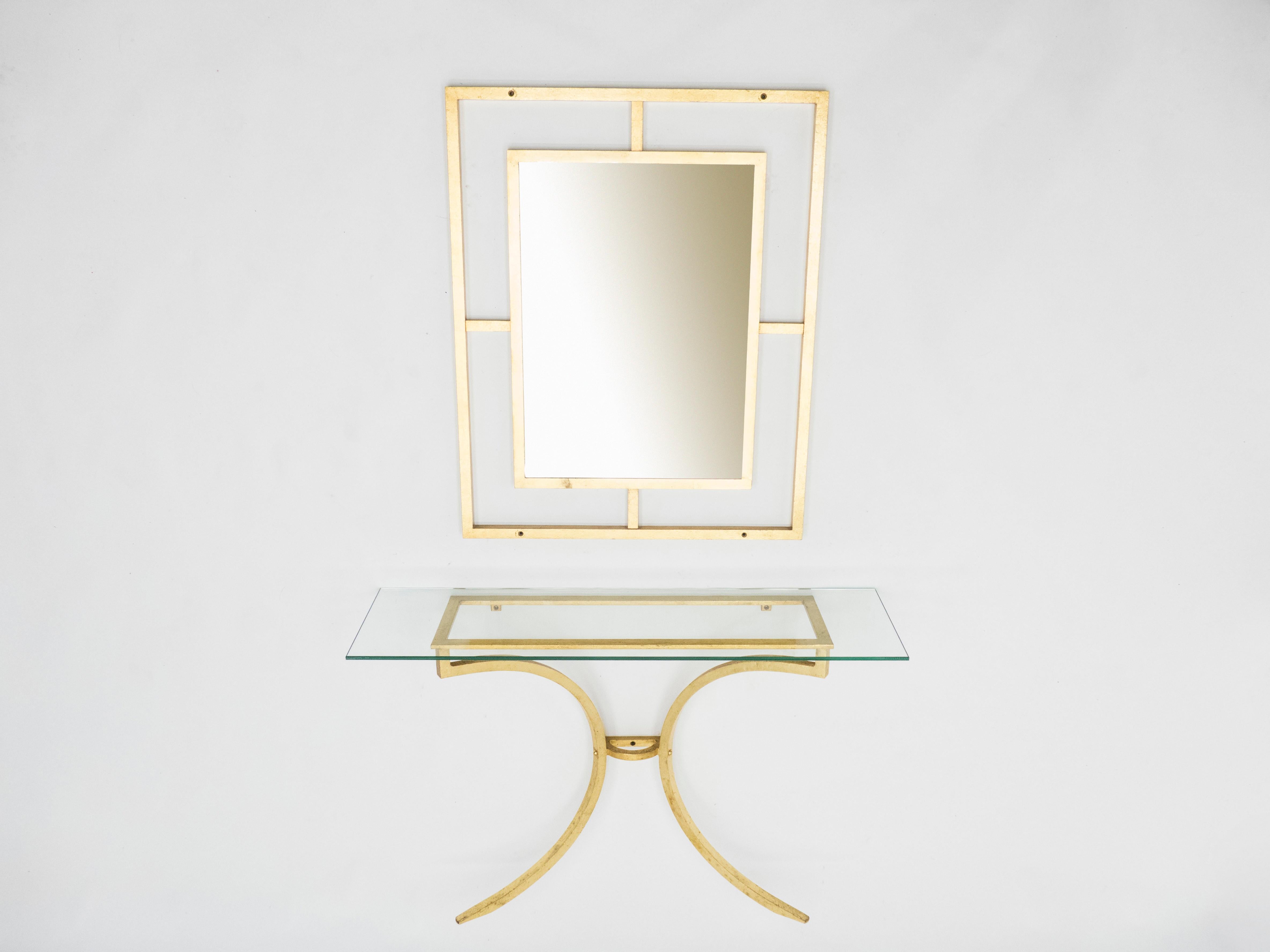 A strategically sparse design with high quality materials gives this rare console with its matching mirror all its appeal. Wrought iron has been gilded with gold leaf for a gentle warm golden patina throughout the entire structure, including all the