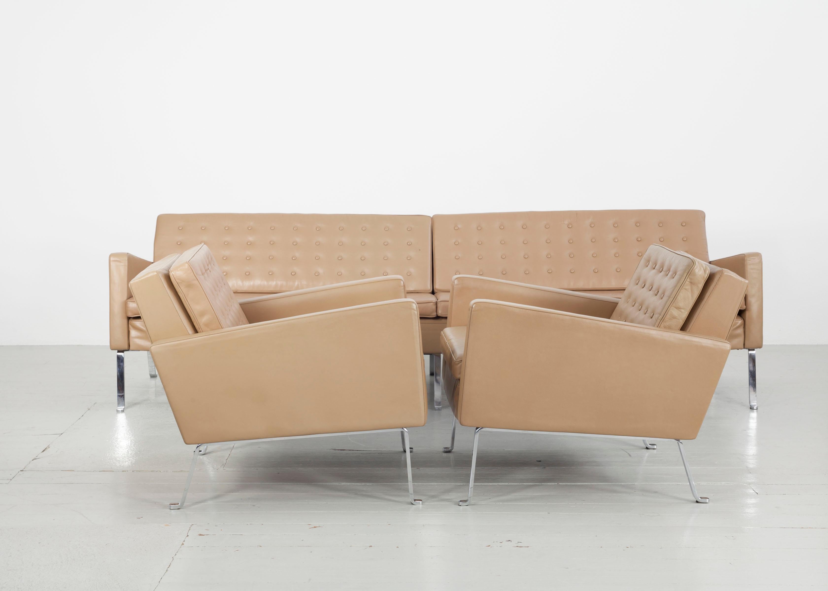 This rare four-seater leather sofa and armchair pair 